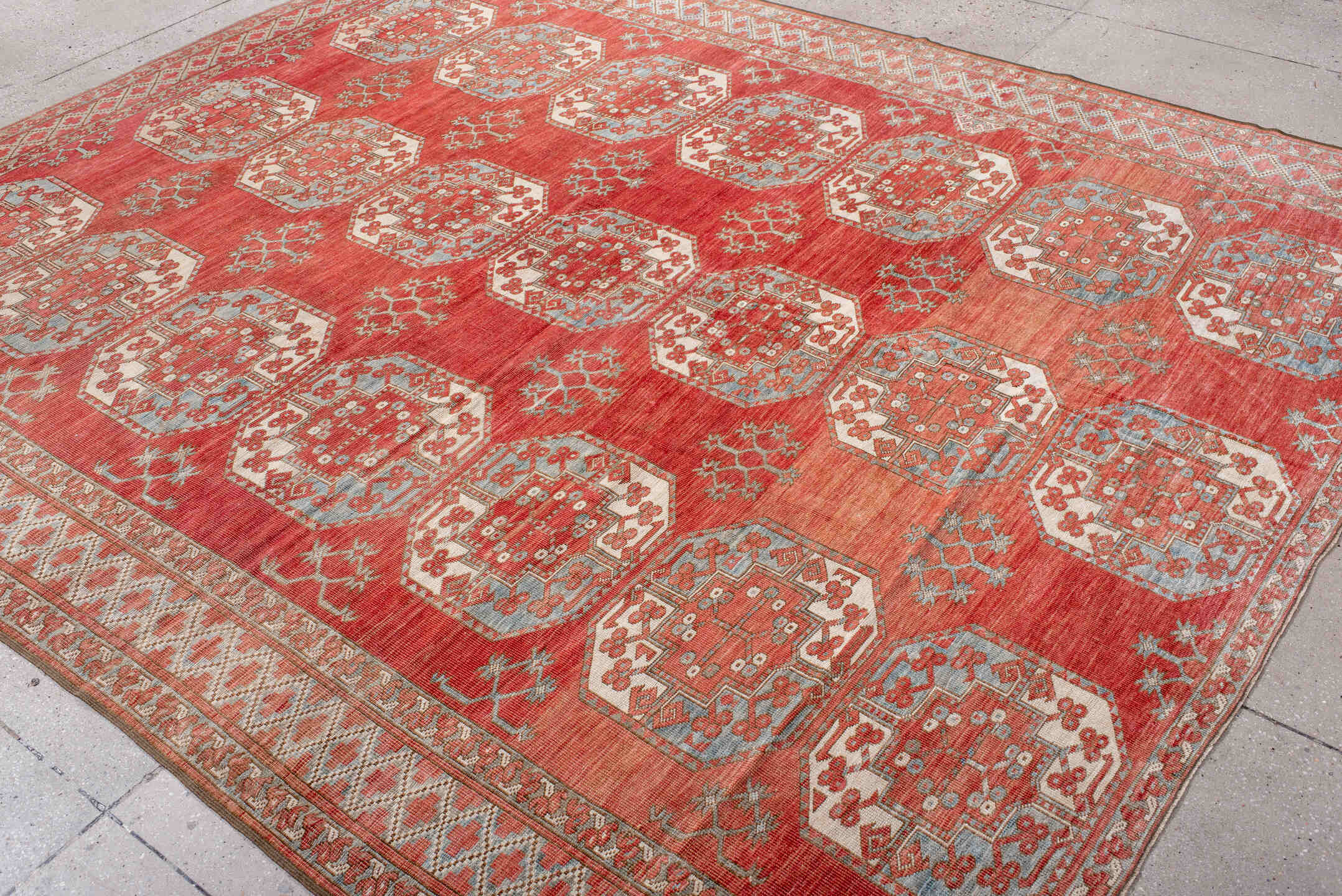 7' x 9' one-of-a-kind handmade antique Afghan rug. Color palette: red, ivory, rust, sky_blue, salmon, terracotta, brown