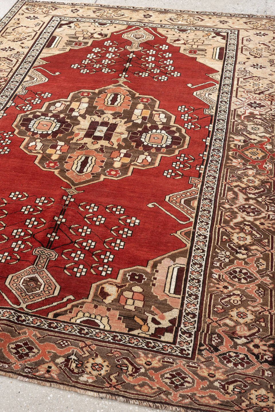 5' x 6' one-of-a-kind handmade antique Caucasian rug. Color palette: terracotta, ivory, taupe, brown, rose, mahogany, camel
