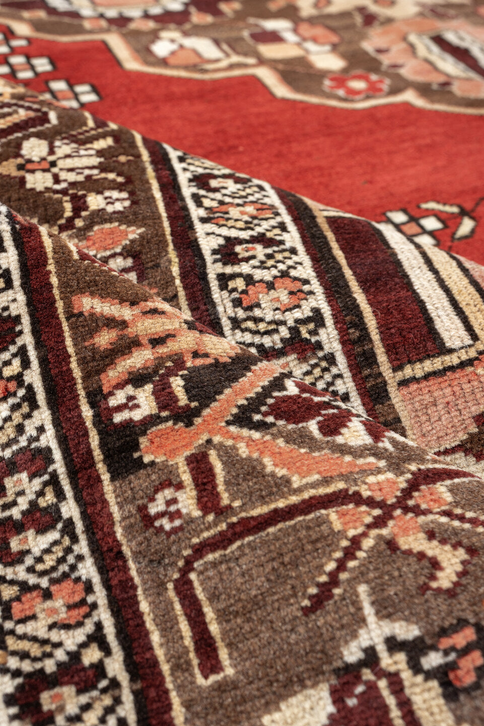 5' x 6' one-of-a-kind handmade antique Caucasian rug. Color palette: terracotta, ivory, taupe, brown, rose, mahogany, camel