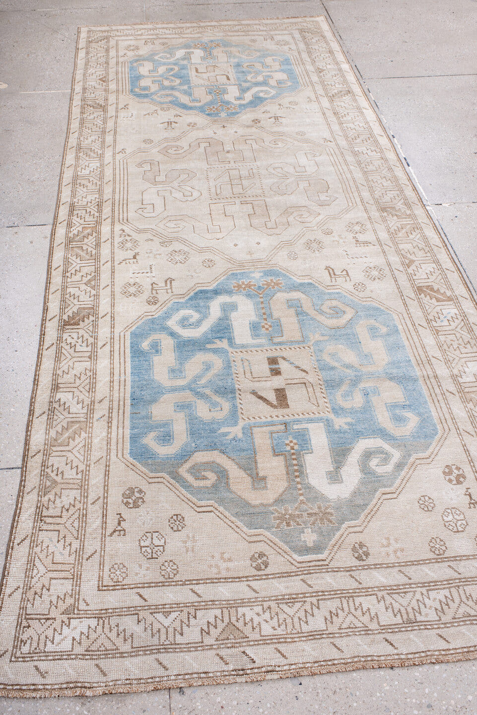 4' x 10' one-of-a-kind handmade vintage Caucasian runner rug. Color palette: ivory, sky blue, taupe, camel, beige