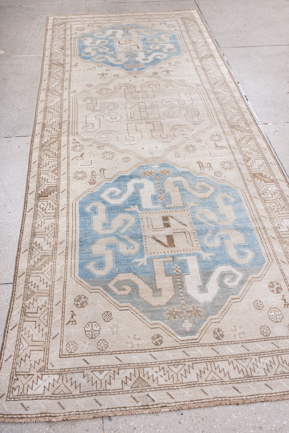 4' x 10' one-of-a-kind handmade vintage Caucasian runner rug. Color palette: ivory, sky blue, taupe, camel, beige