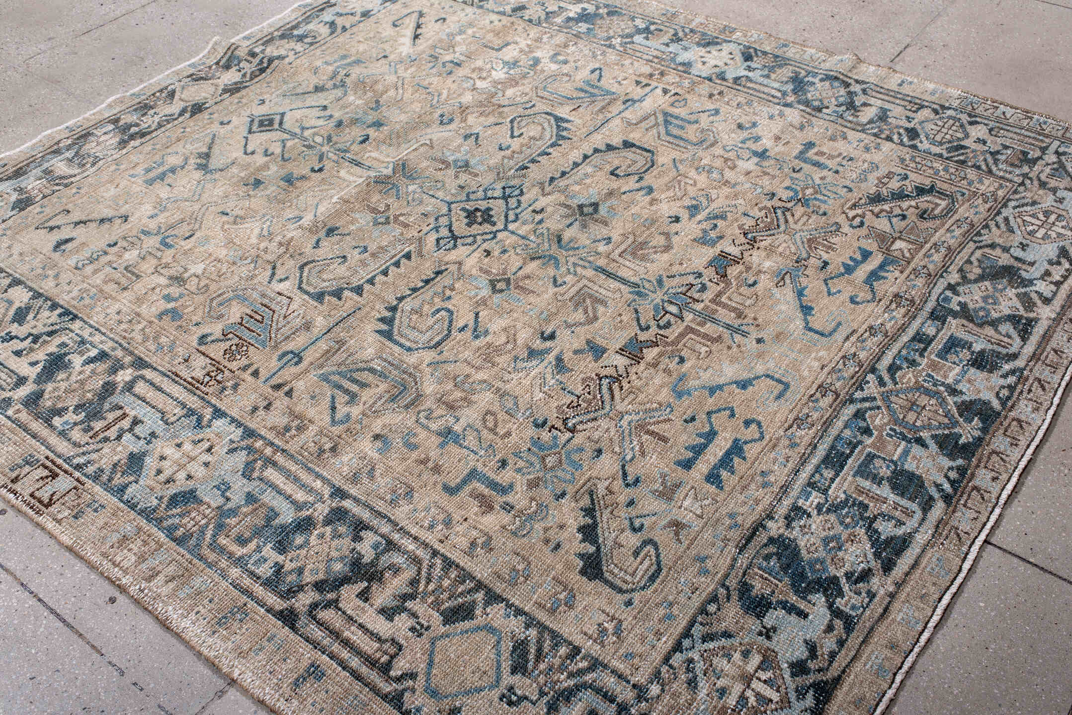 7' x 7' one-of-a-kind handmade antique Heriz rug. Color palette: ivory, beige, slate, taupe, sky blue, charcoal, gray