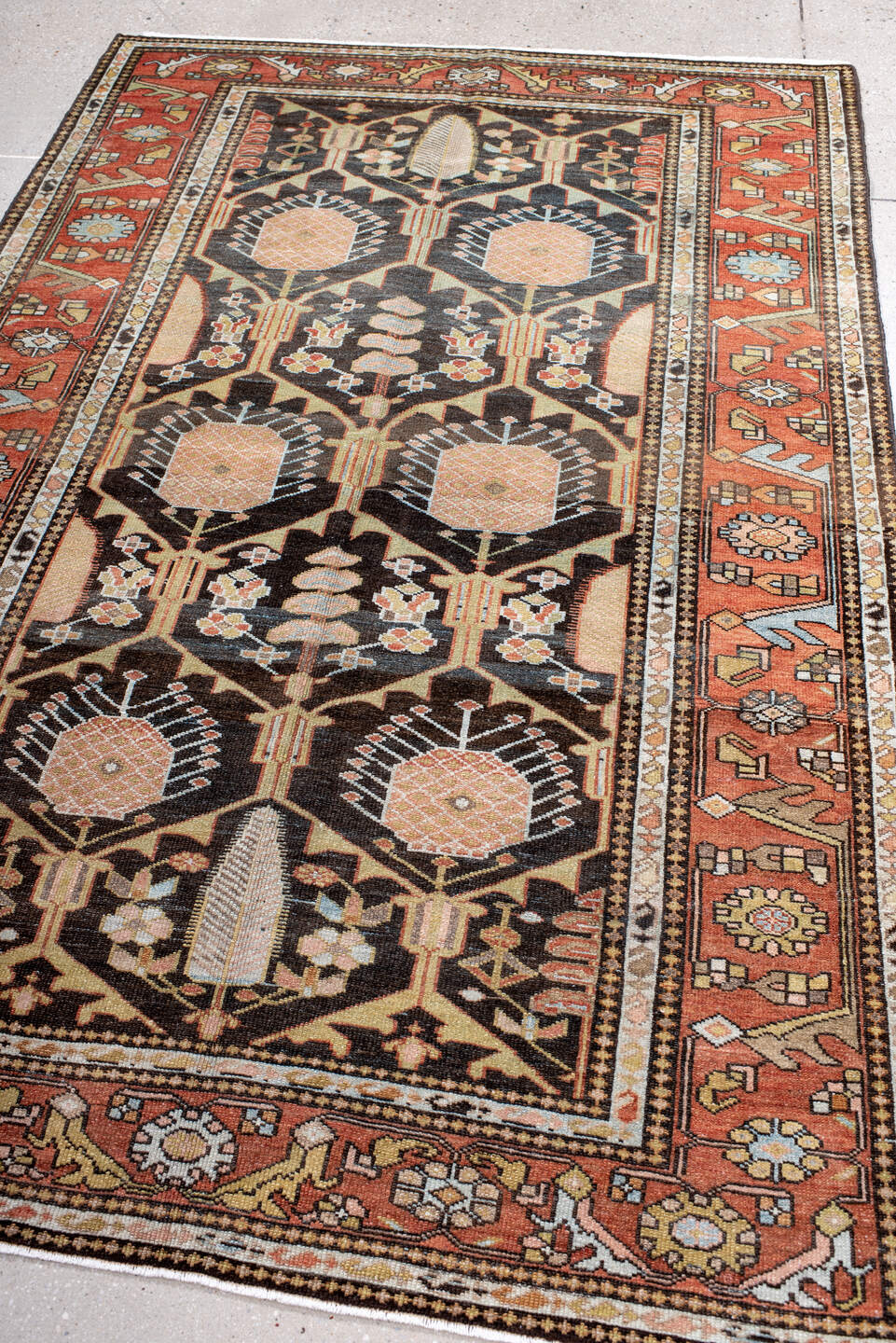 4' x 7' one-of-a-kind handmade antique Baktiary rug. Color palette: rust, charcoal, camel, ivory, soft blue, taupe, gold