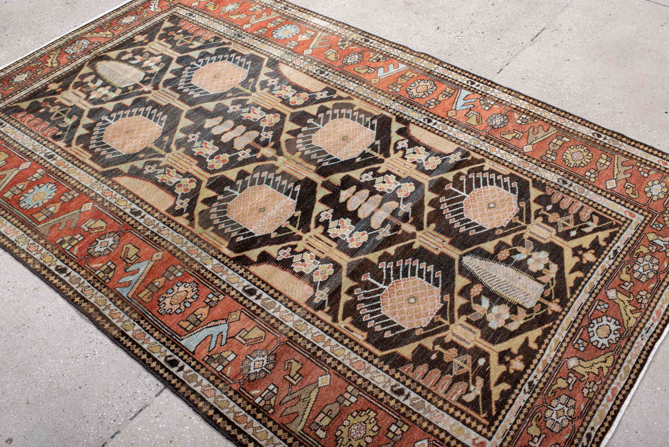 4' x 7' one-of-a-kind handmade antique Baktiary rug. Color palette: rust, charcoal, camel, ivory, soft blue, taupe, gold