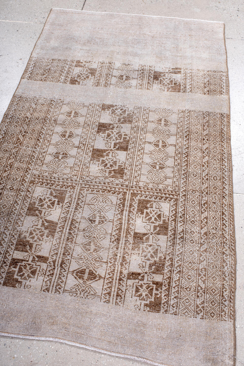 3' x 5' one-of-a-kind handmade vintage Belouch small size rug. Color palette: ivory, taupe, beige, camel, brown, gray