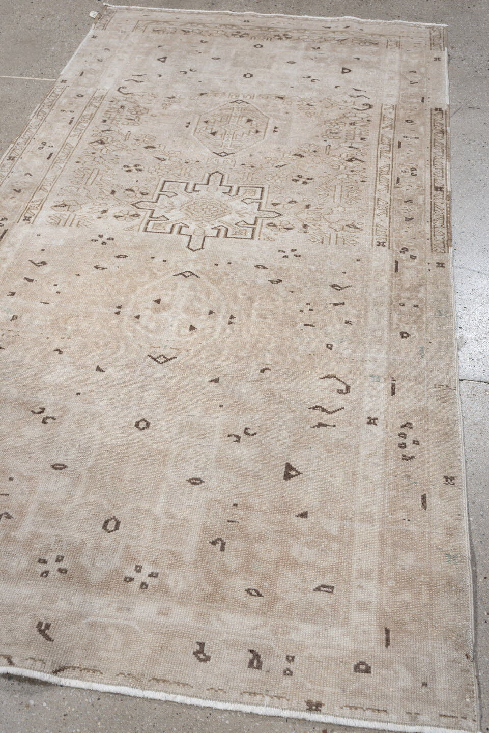6' x 3' one-of-a-kind handmade vintage Karaje rug. Color palette: ivory, taupe, beige, camel, brown, gray