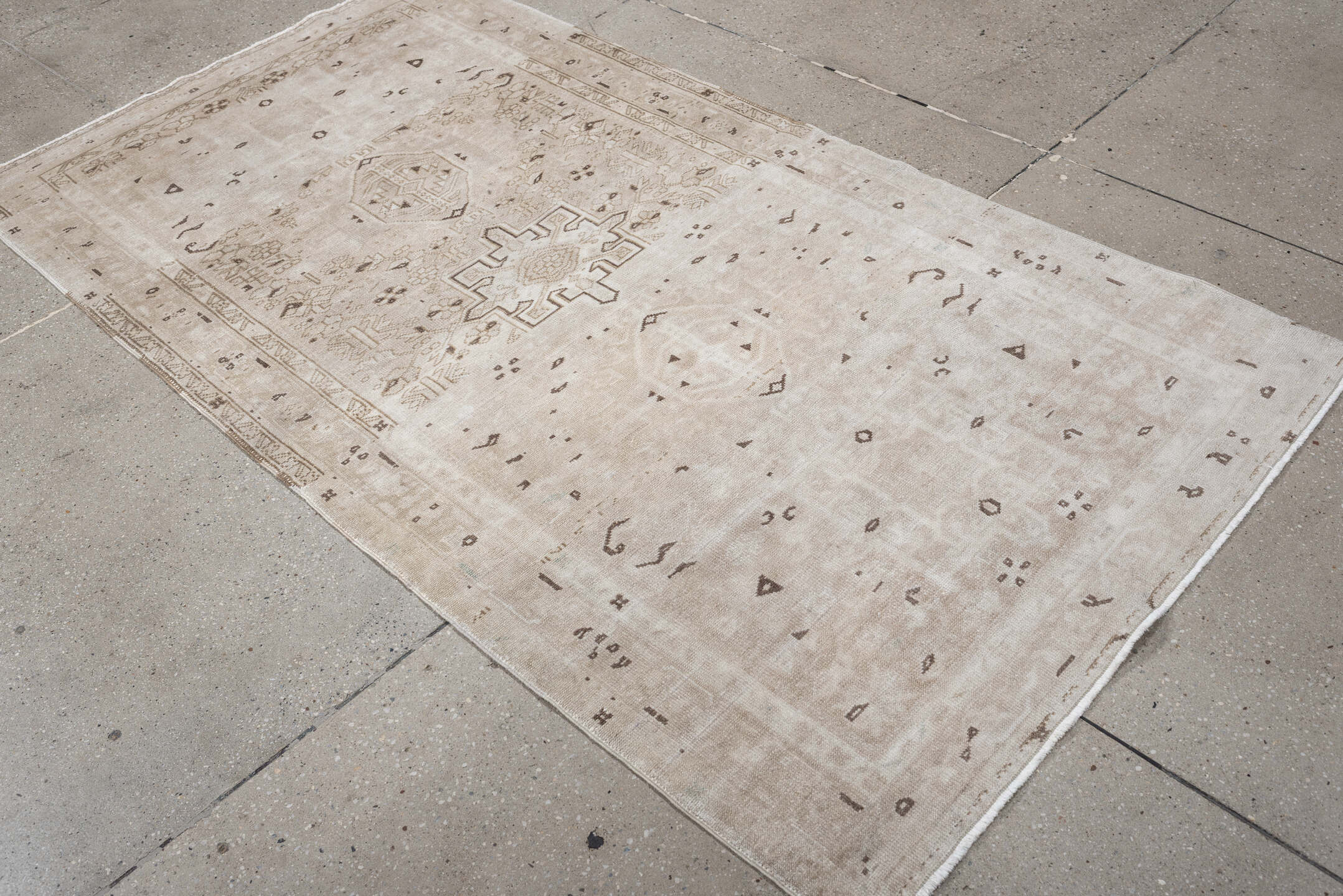 6' x 3' one-of-a-kind handmade vintage Karaje rug. Color palette: ivory, taupe, beige, camel, brown, gray