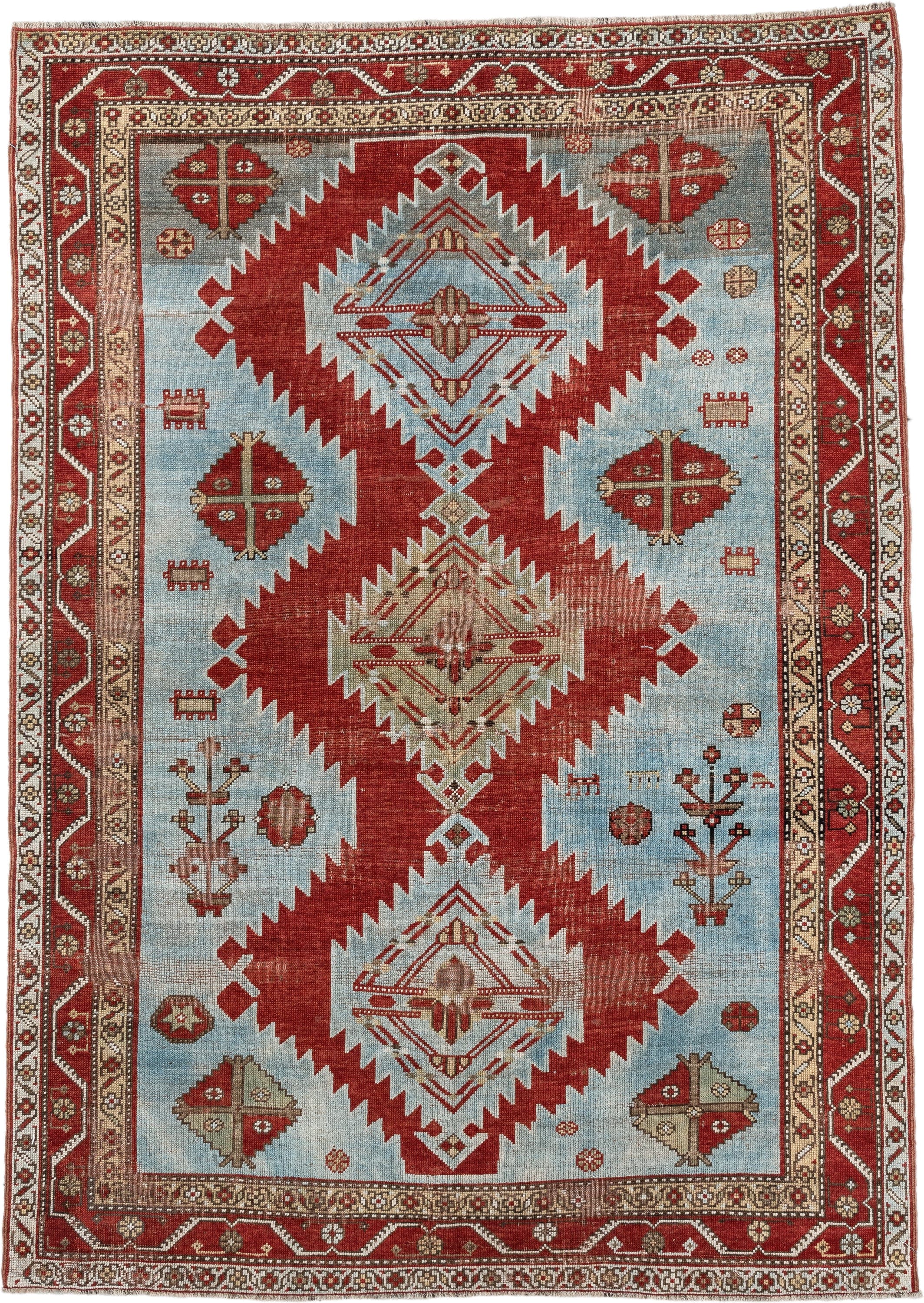 5' x 7' one-of-a-kind handmade antique Caucasian rug. Color palette: rust, sky blue, ivory, camel, taupe, crimson