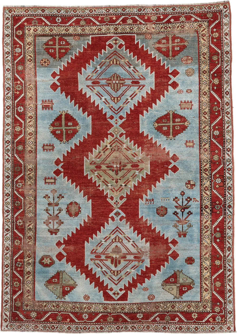 5' x 7' one-of-a-kind handmade antique Caucasian rug. Color palette: rust, sky blue, ivory, camel, taupe, crimson