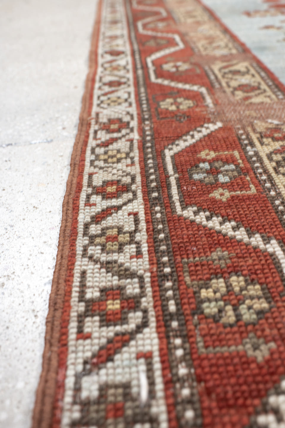 5' x 7' one-of-a-kind handmade antique Caucasian rug. Color palette: rust, sky blue, ivory, camel, taupe, crimson