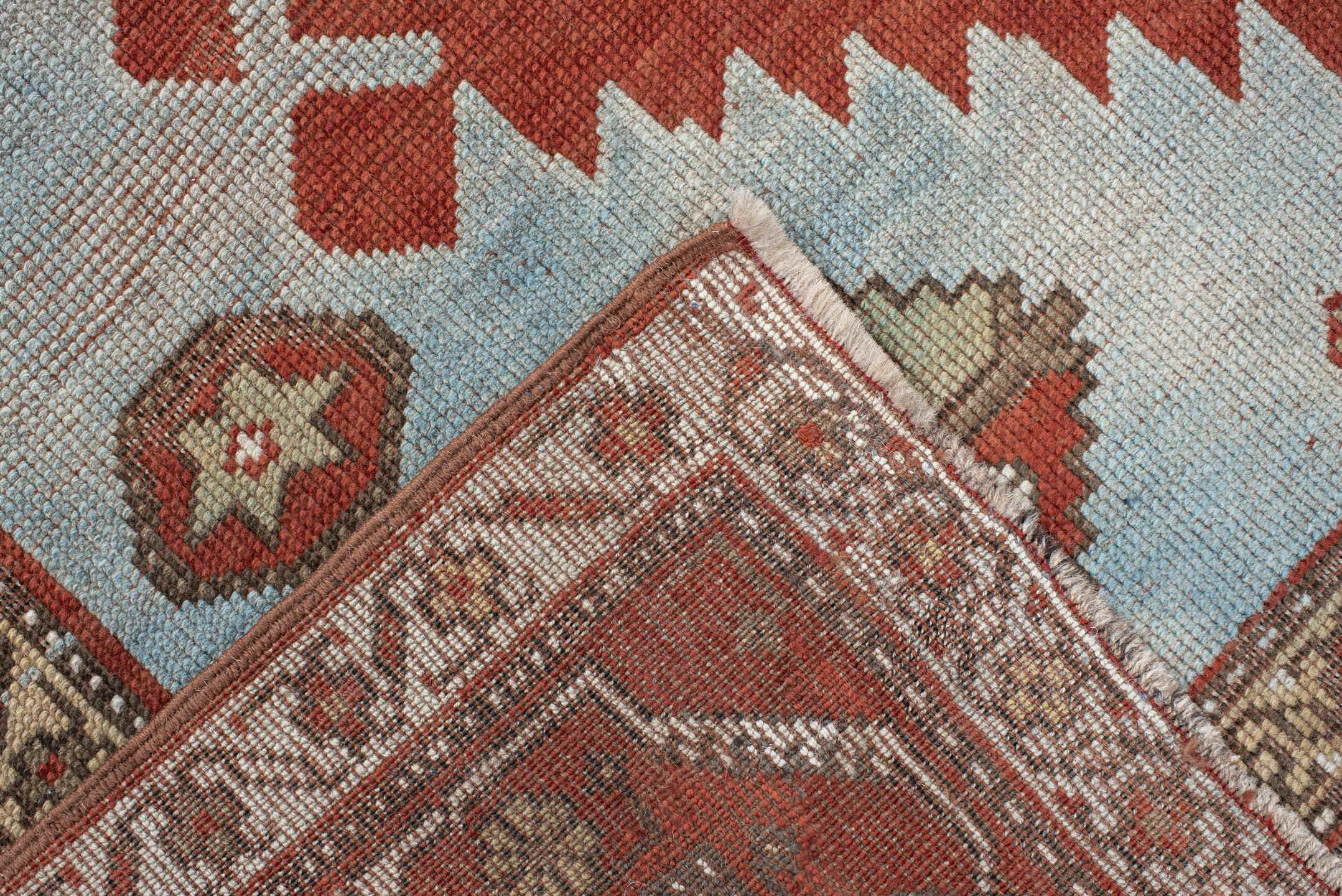 5' x 7' one-of-a-kind handmade antique Caucasian rug. Color palette: rust, sky blue, ivory, camel, taupe, crimson