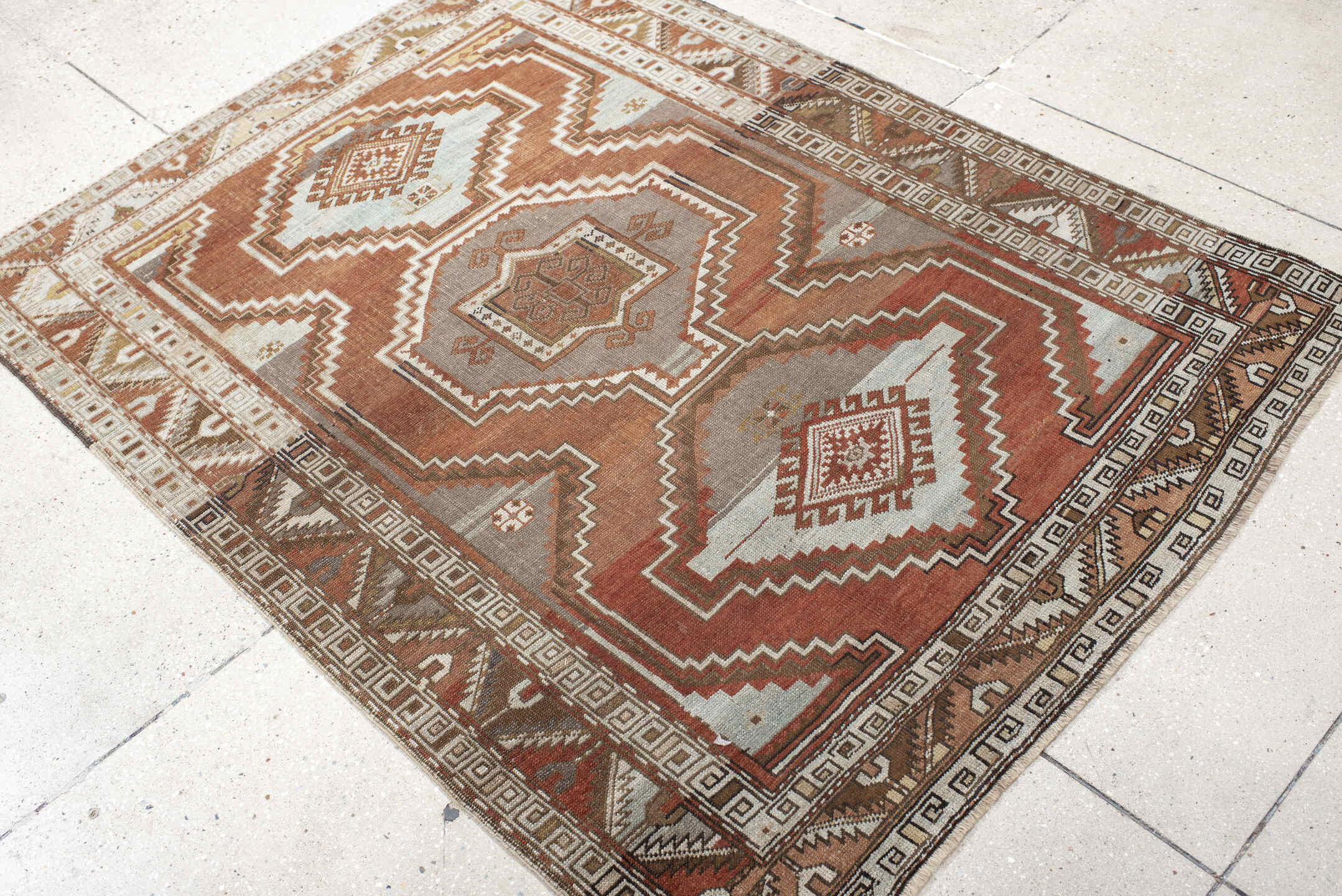 4' x 5' one-of-a-kind handmade vintage Caucasian small size rug. Color palette: brown, floral white, gray, light gray, linen