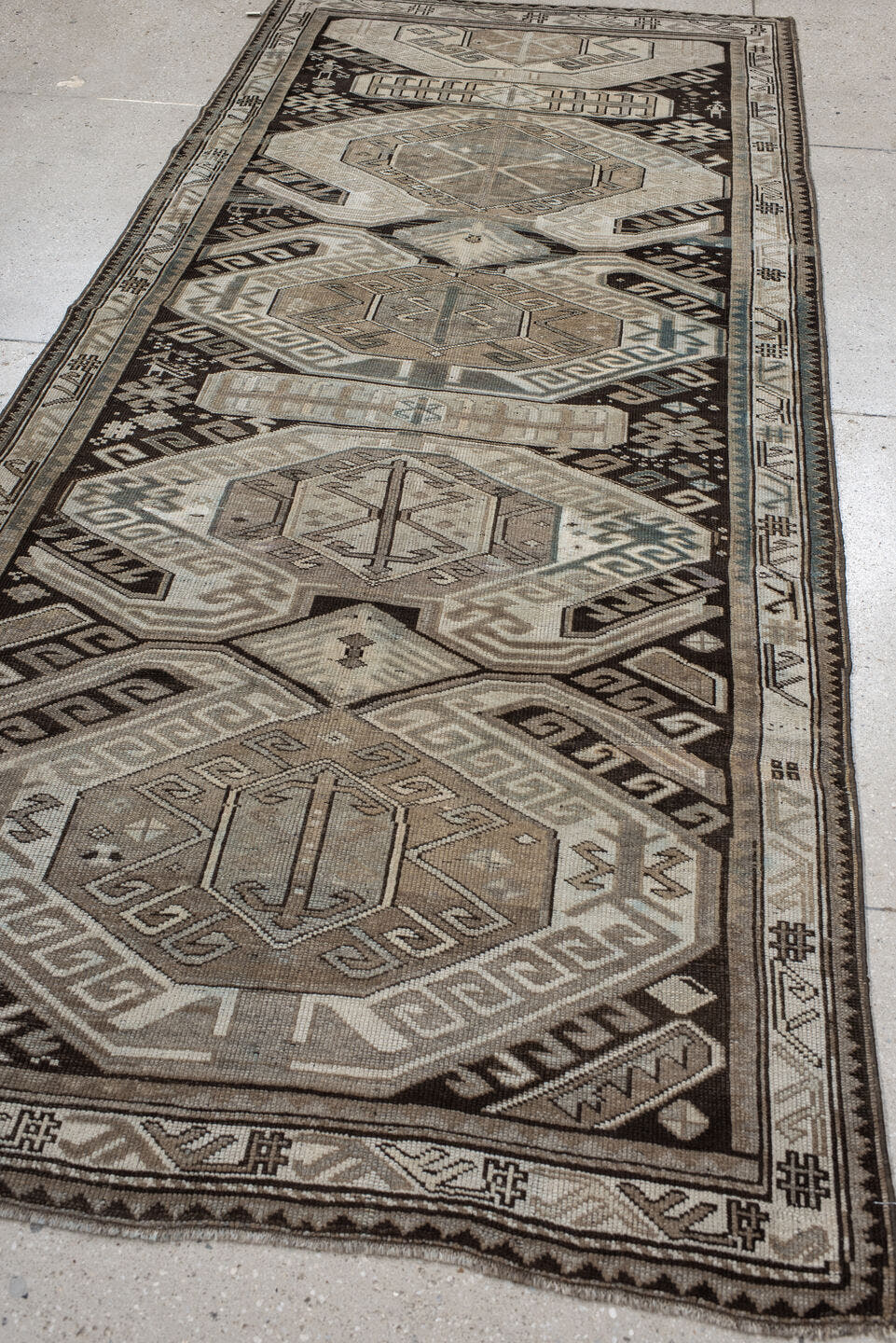4' x 10' one-of-a-kind handmade antique Caucasian runner rug. Color palette: ivory, charcoal, taupe, brown, slate, gray