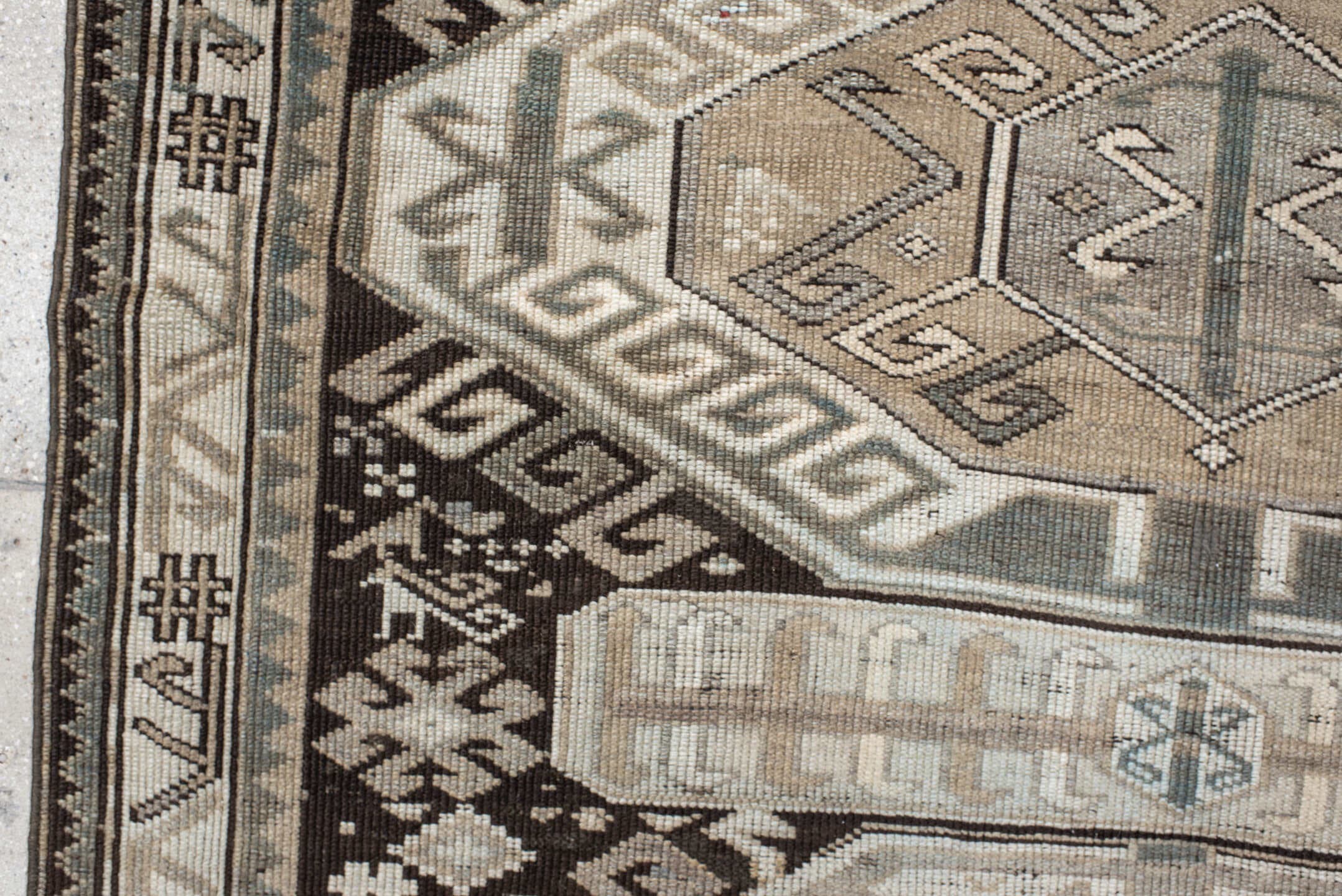 4' x 10' one-of-a-kind handmade antique Caucasian runner rug. Color palette: ivory, charcoal, taupe, brown, slate, gray