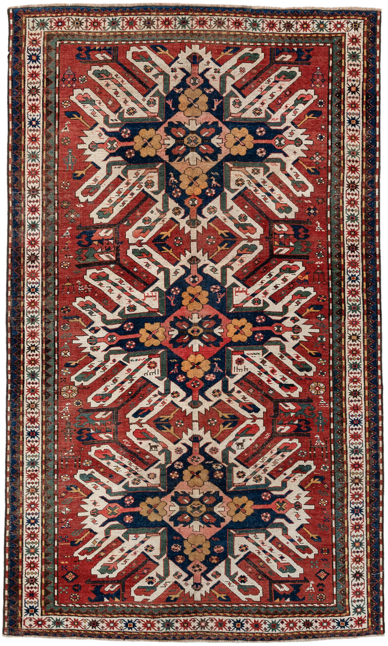 5' x 8' one-of-a-kind handmade antique Kazak medium size rug. Color palette: rust, ivory, navy, sage, gold, crimson, rose