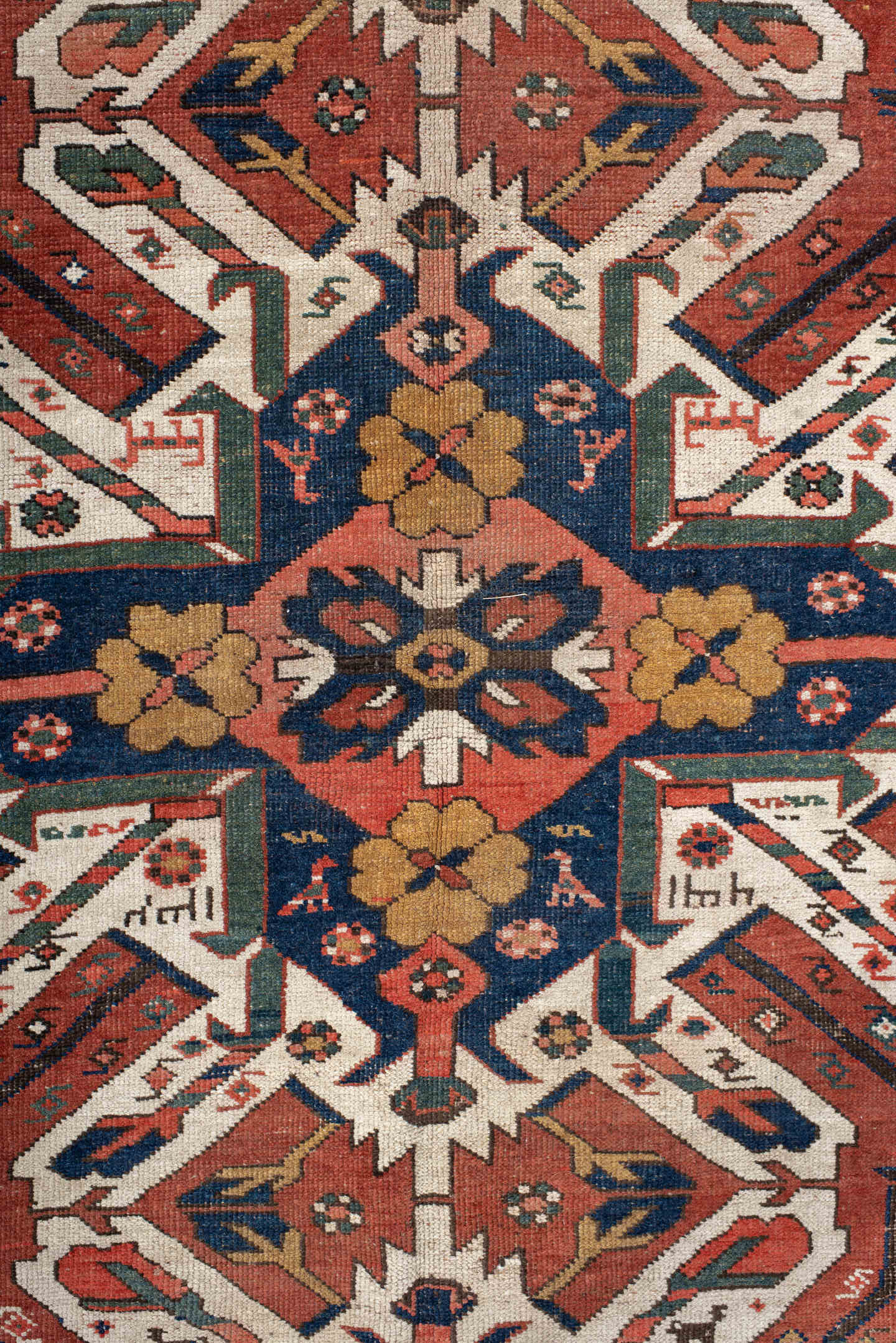 5' x 8' one-of-a-kind handmade antique Kazak medium size rug. Color palette: rust, ivory, navy, sage, gold, crimson, rose