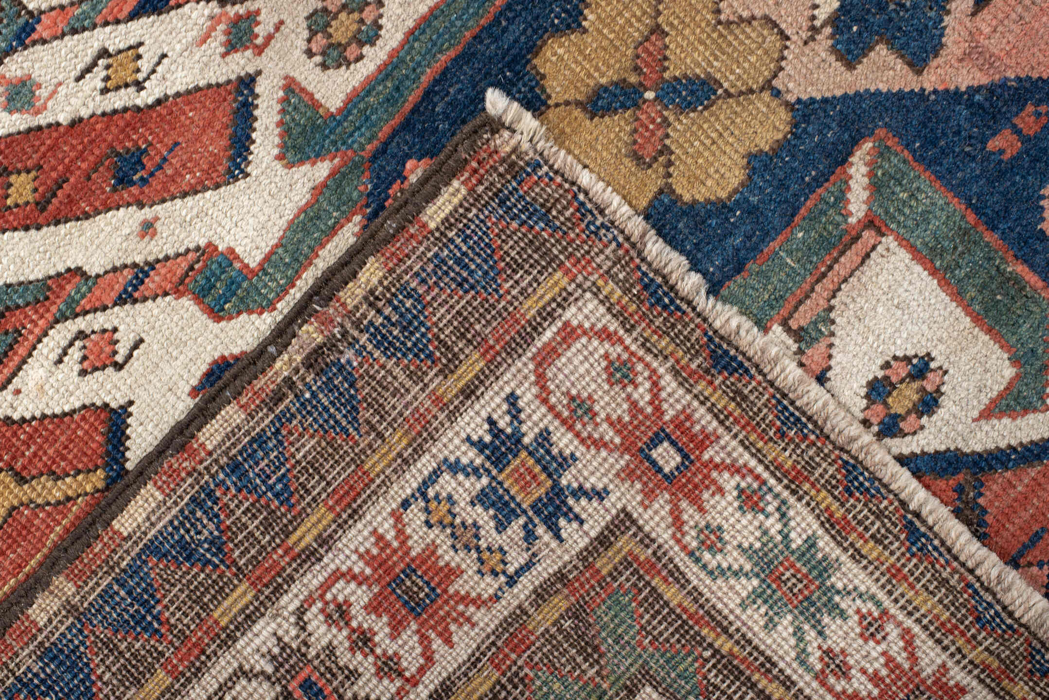 5' x 8' one-of-a-kind handmade antique Kazak medium size rug. Color palette: rust, ivory, navy, sage, gold, crimson, rose