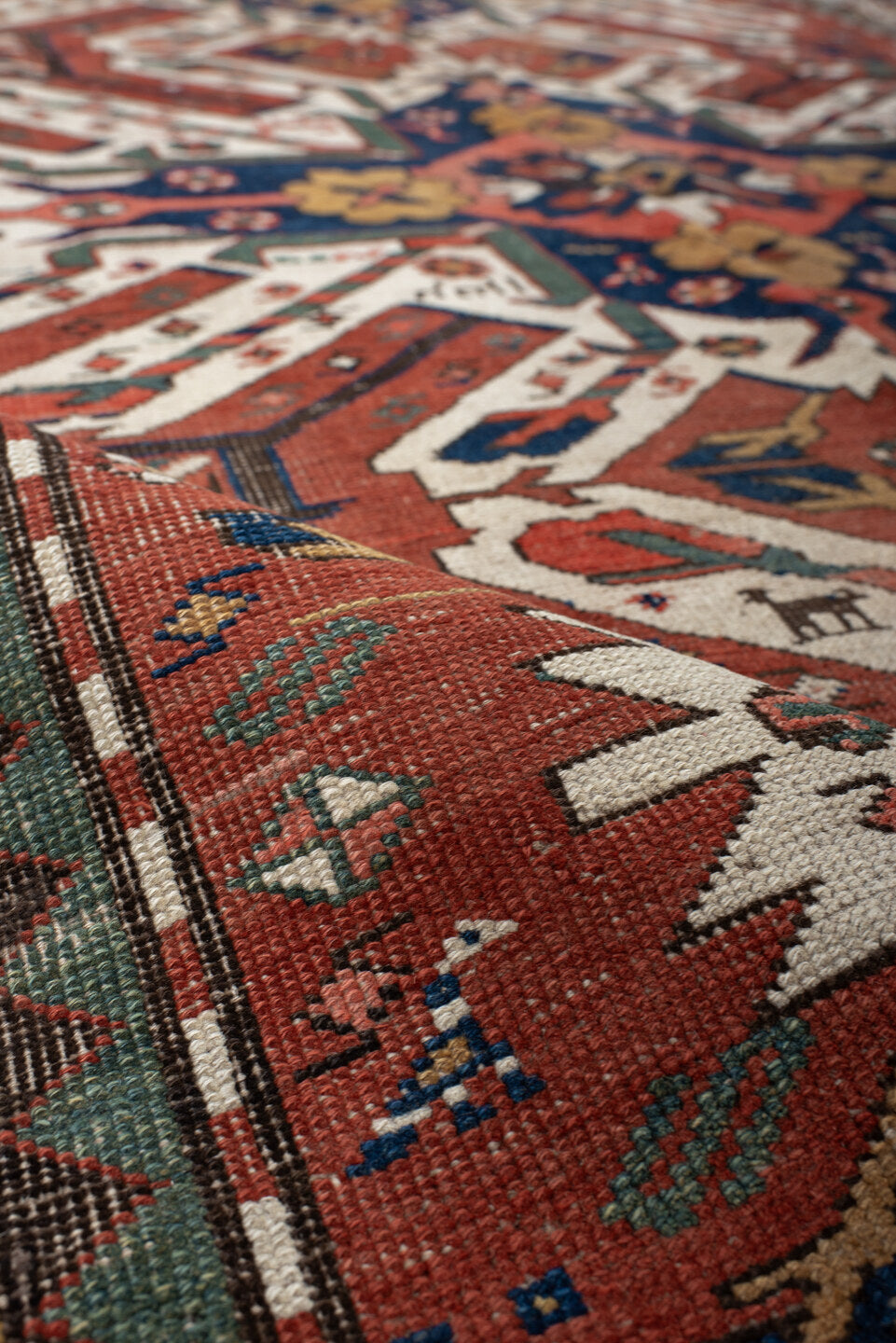 5' x 8' one-of-a-kind handmade antique Kazak medium size rug. Color palette: rust, ivory, navy, sage, gold, crimson, rose