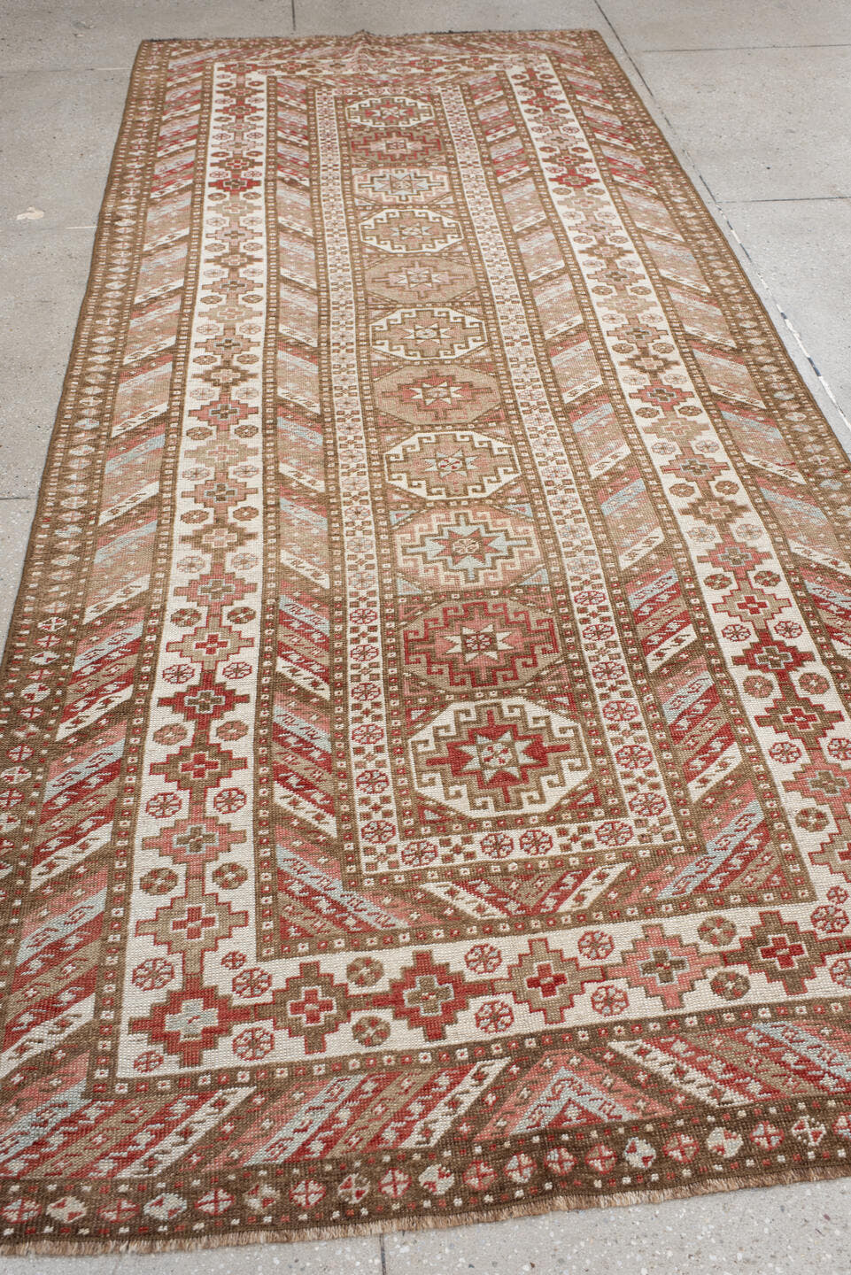 4' x 10' one-of-a-kind handmade antique Caucasian runner rug. Color palette: ivory, taupe, rose, rust, camel, brown, beige