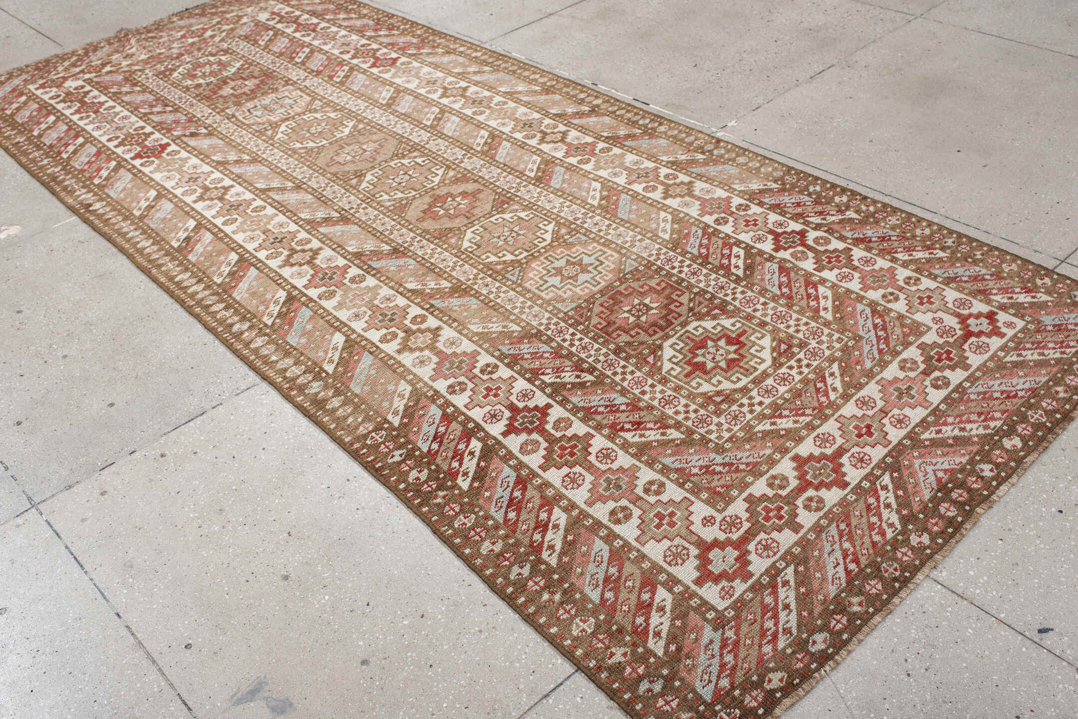 4' x 10' one-of-a-kind handmade antique Caucasian runner rug. Color palette: ivory, taupe, rose, rust, camel, brown, beige