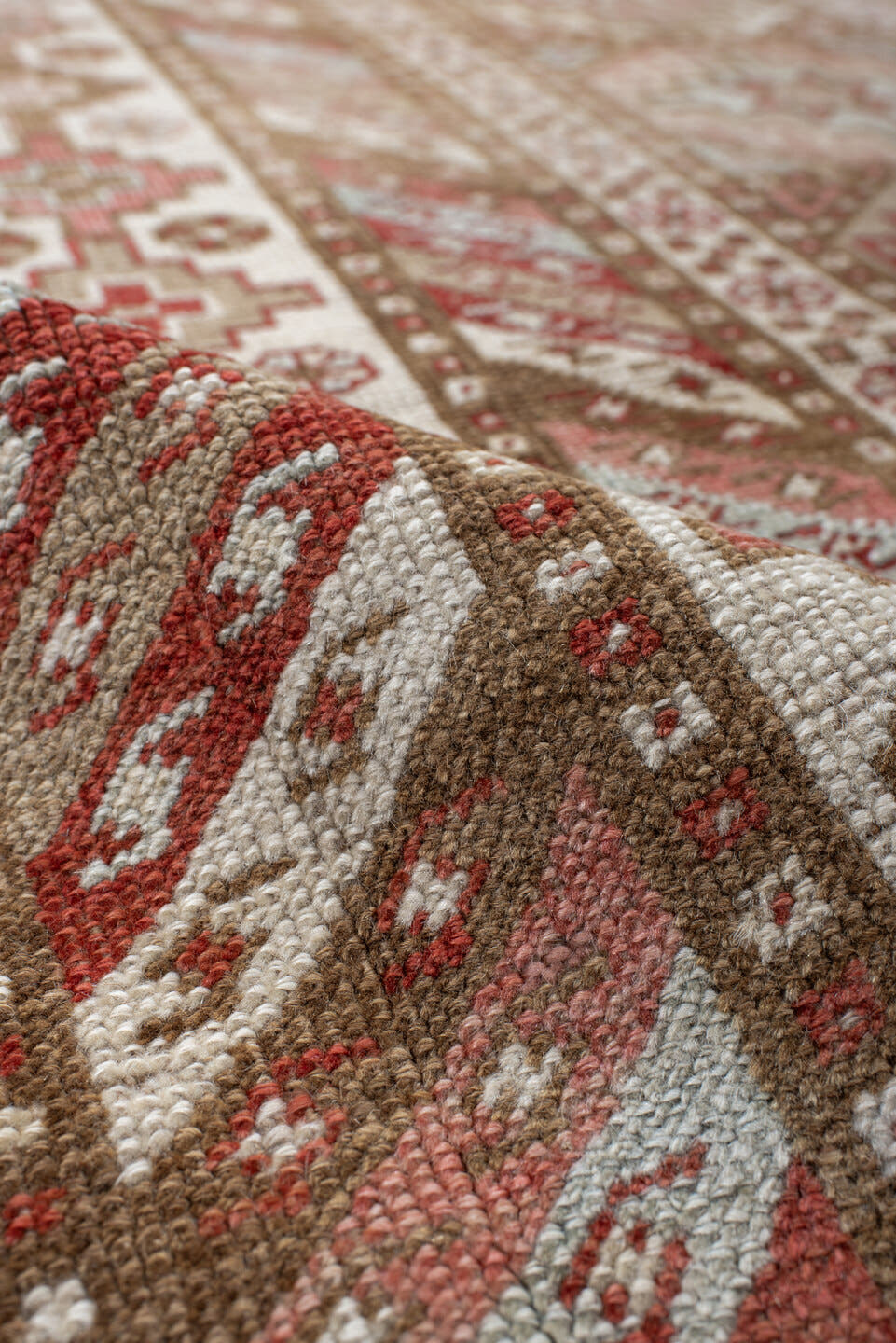 4' x 10' one-of-a-kind handmade antique Caucasian runner rug. Color palette: ivory, taupe, rose, rust, camel, brown, beige