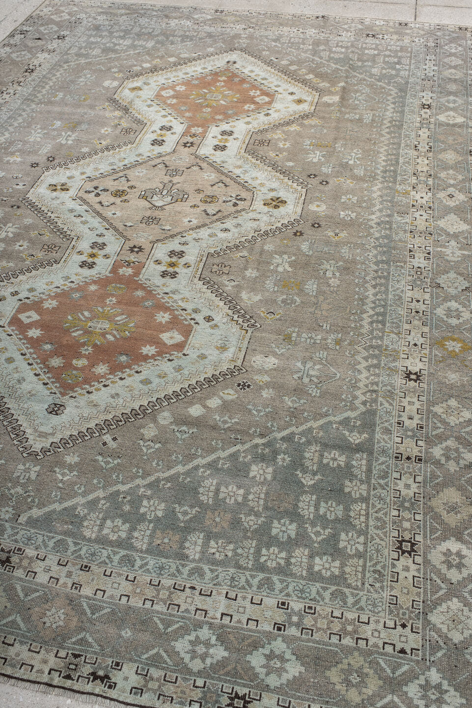 6' x 10' one-of-a-kind handmade antique Qashqai large size rug. Color palette: taupe, ivory, camel, rose, gold, brown, cream
