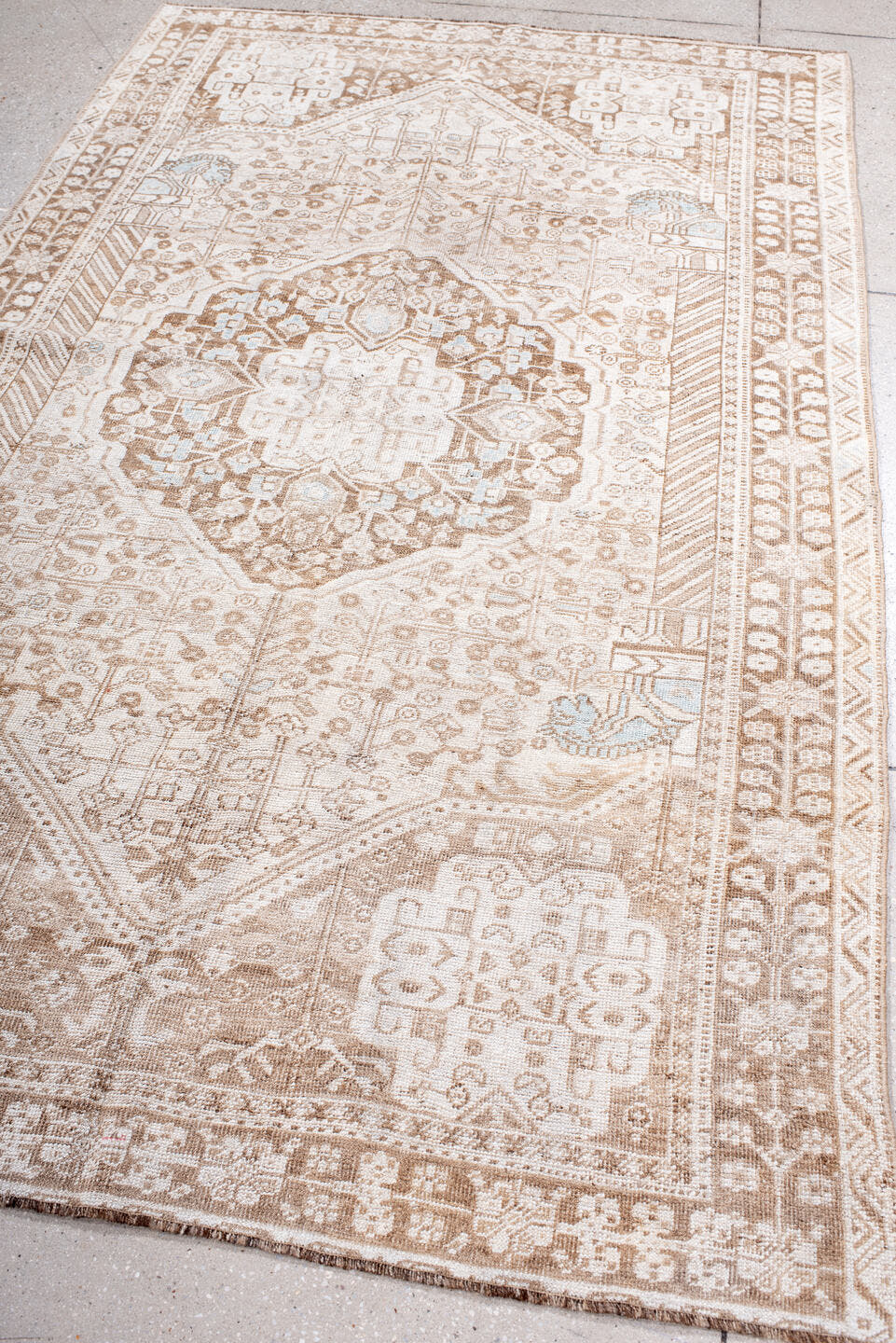 4' x 8' one-of-a-kind handmade antique Shiraz rug. Color palette: ivory, taupe, camel, pale blue, beige, light brown, gray