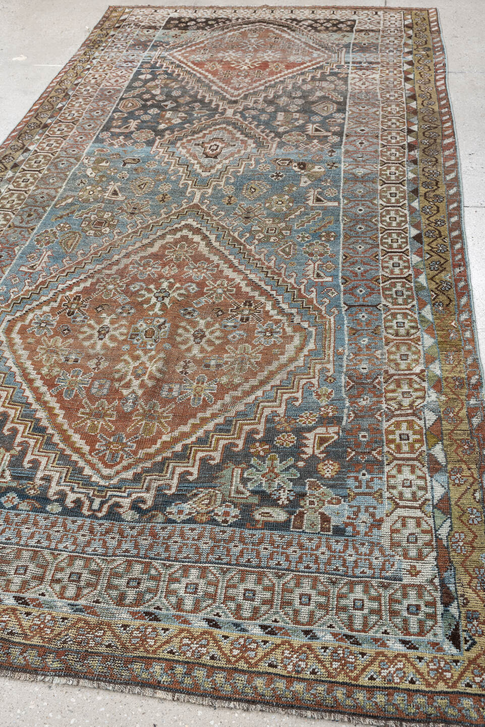5' x 10' one-of-a-kind handmade vintage Shiraz runner rug. Color palette: sky blue, rust, ivory, brown, camel, charcoal