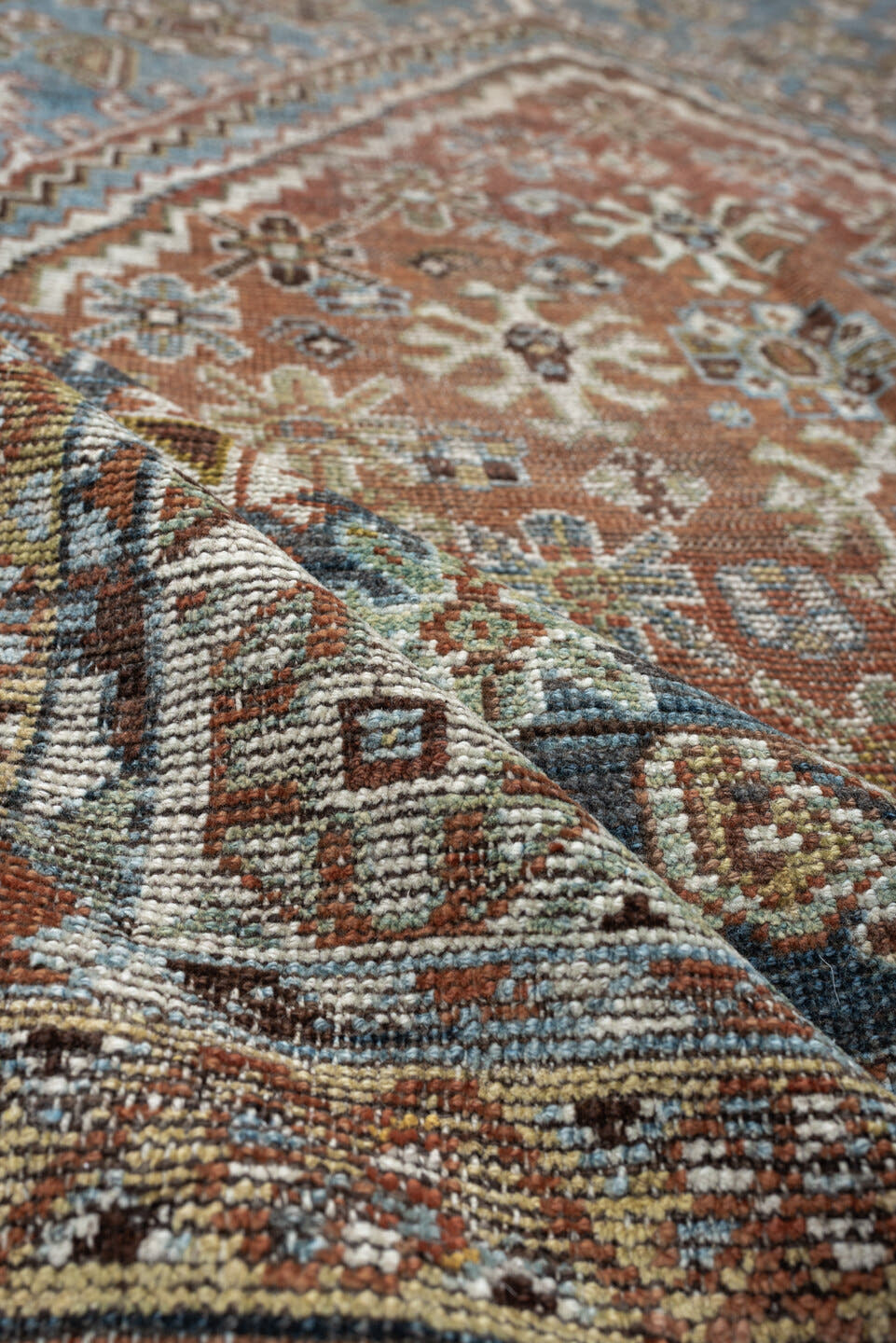 5' x 10' one-of-a-kind handmade vintage Shiraz runner rug. Color palette: sky blue, rust, ivory, brown, camel, charcoal
