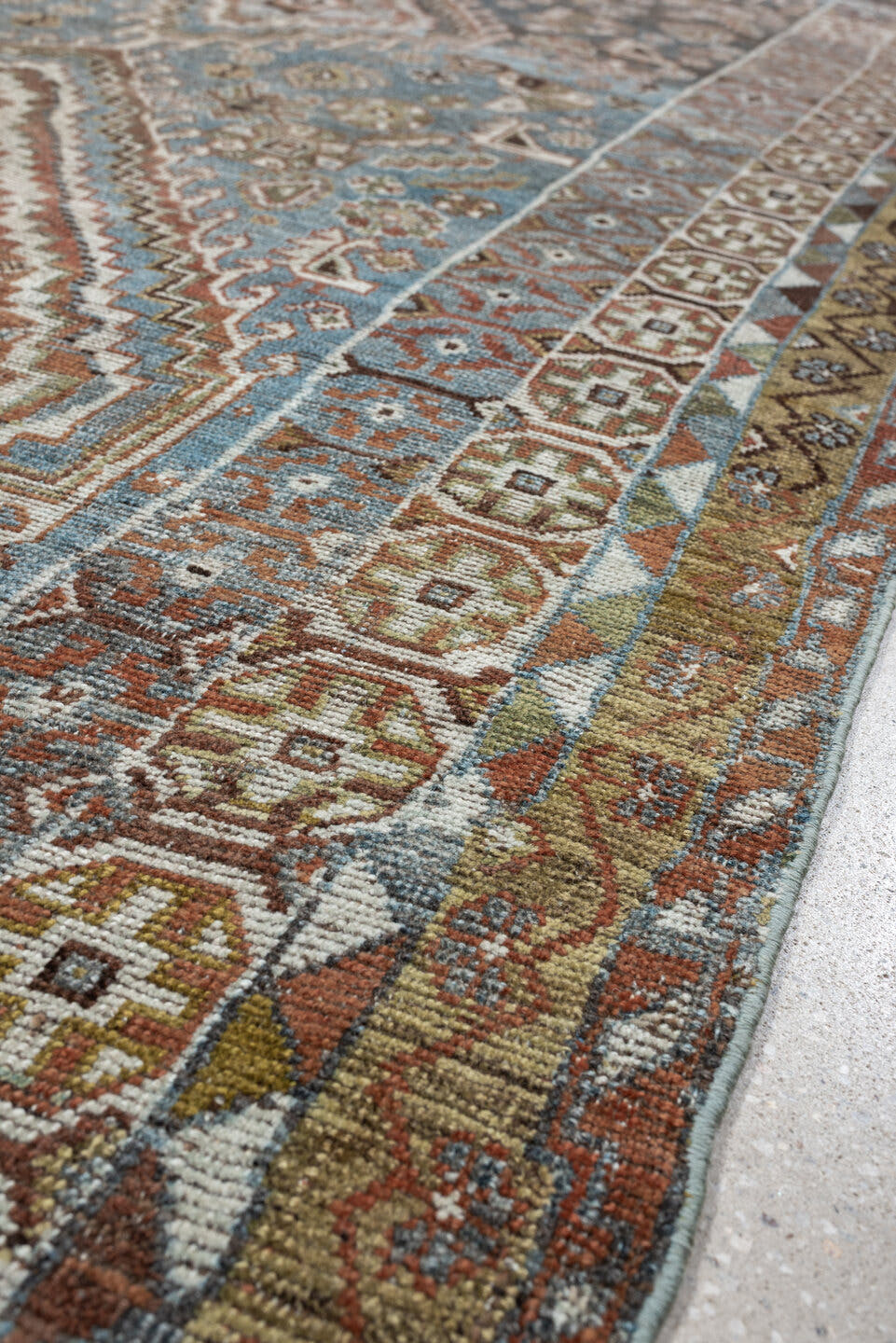 5' x 10' one-of-a-kind handmade vintage Shiraz runner rug. Color palette: sky blue, rust, ivory, brown, camel, charcoal