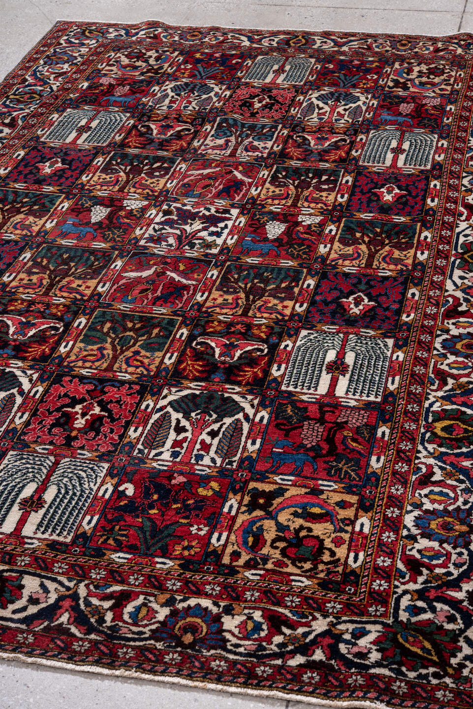 5' x 8' one-of-a-kind handmade antique Baktiary medium size rug. Color palette: red, navy, ivory, burgundy, cobalt, camel