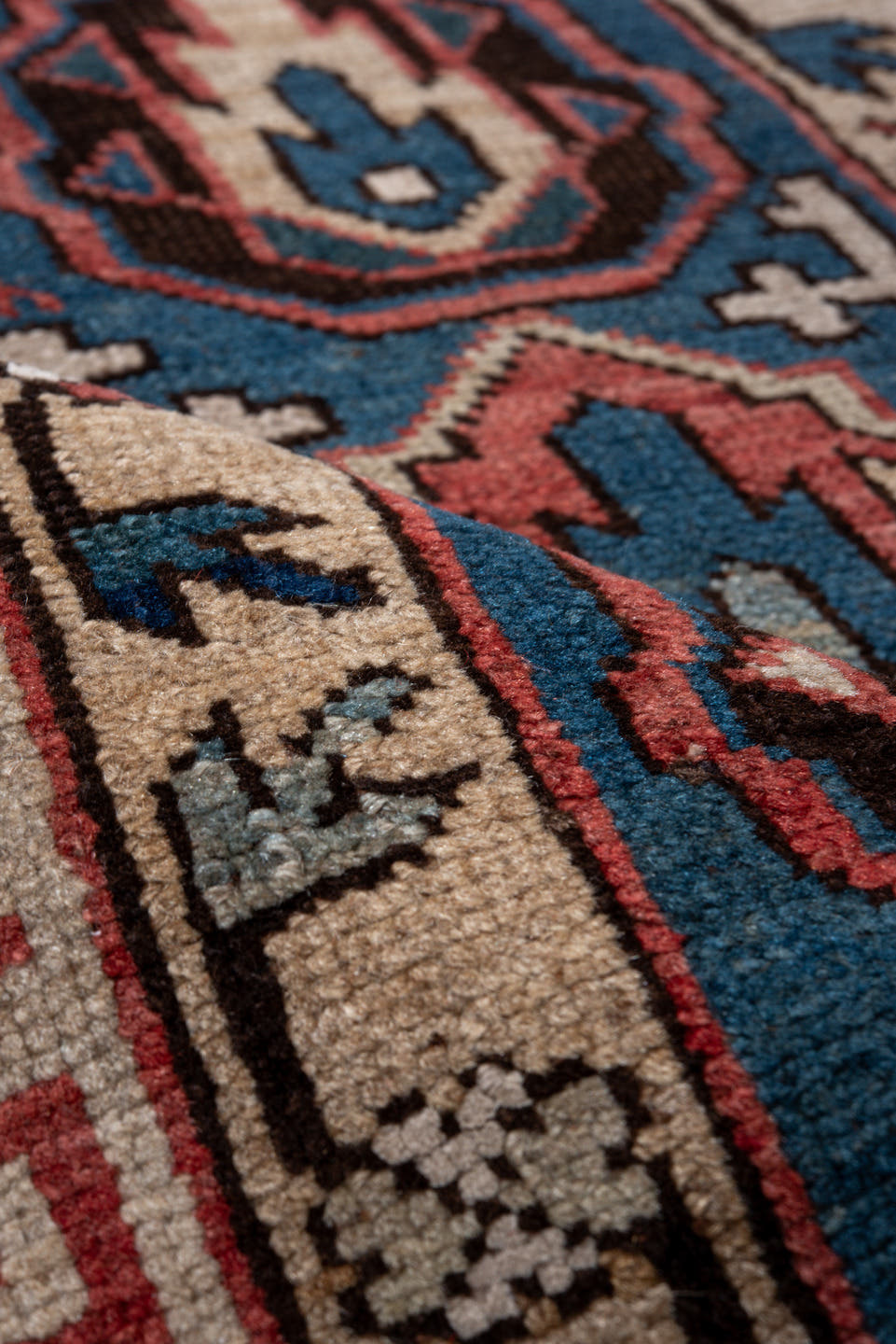 2' x 4' one-of-a-kind handmade vintage Caucasian small size rug. Color palette: blue, ivory, rust, brown, navy, pink, black