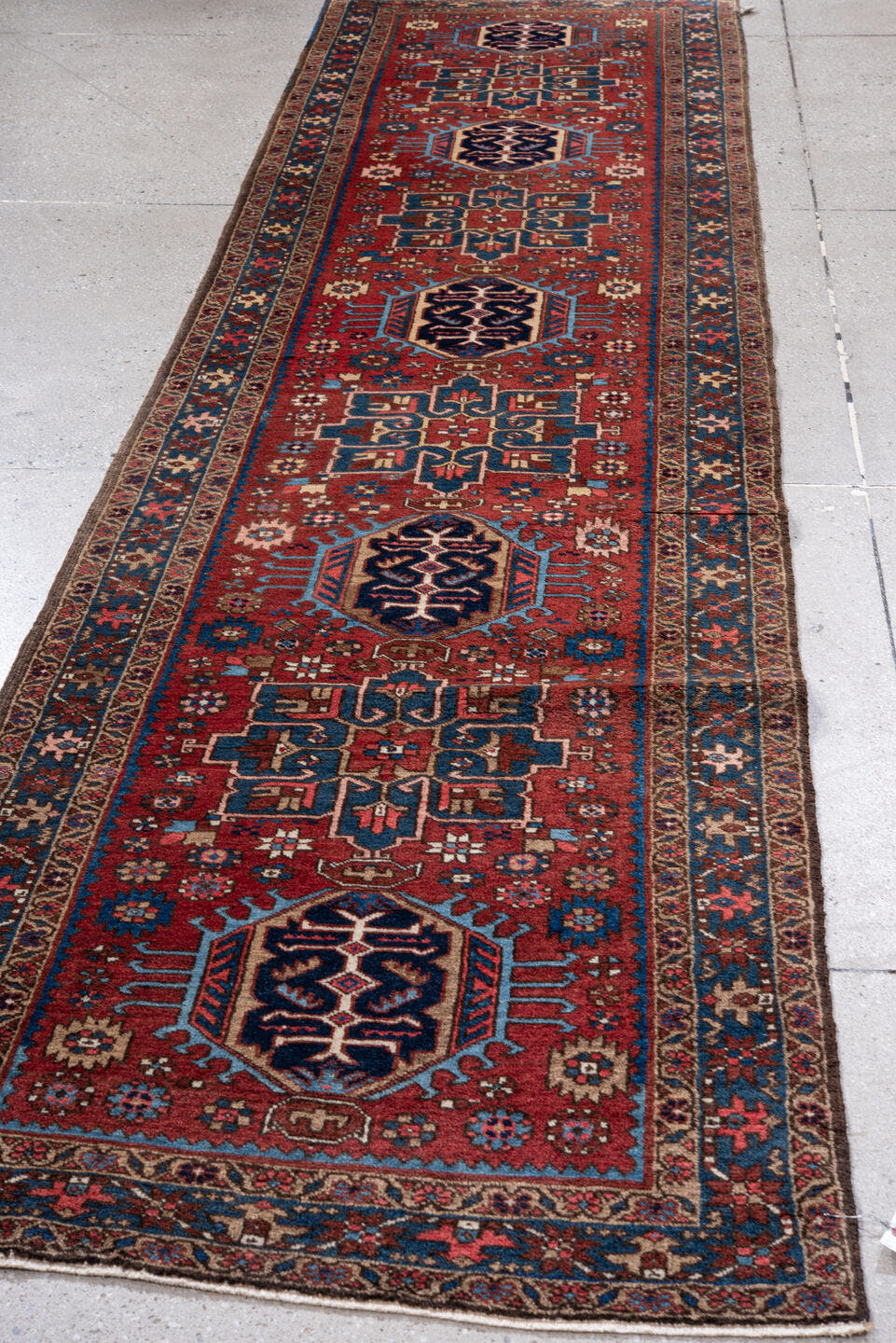 2' x 11' one-of-a-kind handmade vintage Heriz runner rug. Color palette: red, navy, ivory, sky blue, rust, camel, charcoal