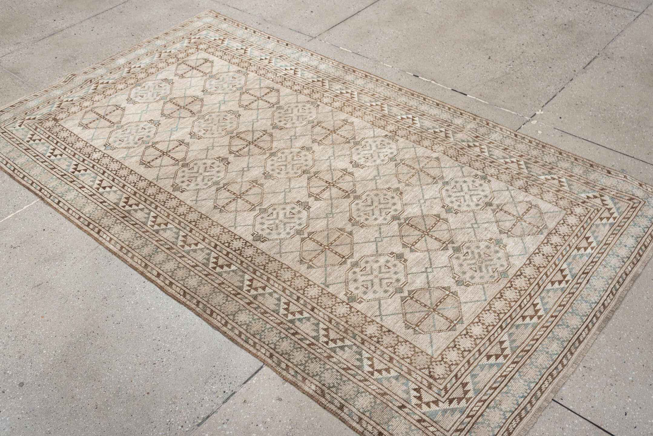 6' x 3' one-of-a-kind handmade antique Afghan rug. Color palette: ivory, taupe, pale blue, beige, camel, light brown, gray