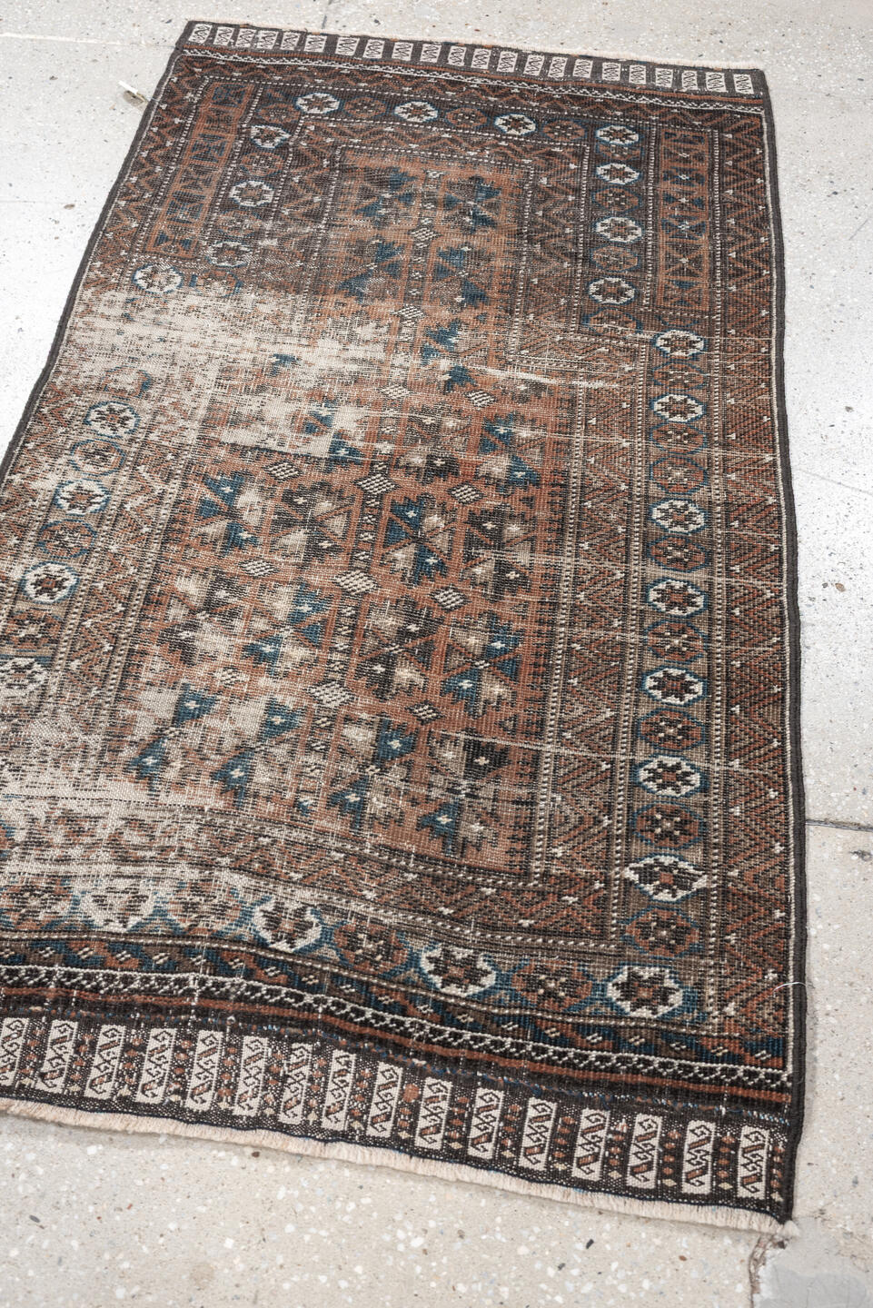 2' x 4' one-of-a-kind handmade antique Belouch small size rug. Color palette: rust, indigo, ivory, charcoal, camel, taupe