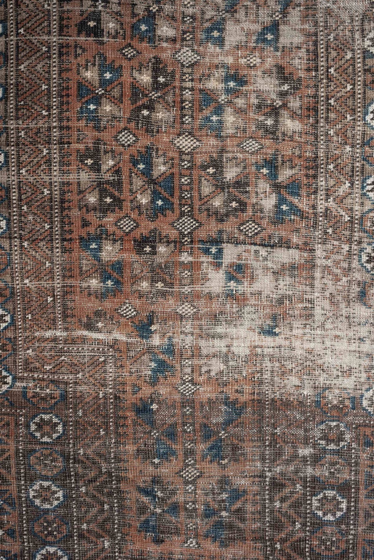 2' x 4' one-of-a-kind handmade antique Belouch small size rug. Color palette: rust, indigo, ivory, charcoal, camel, taupe