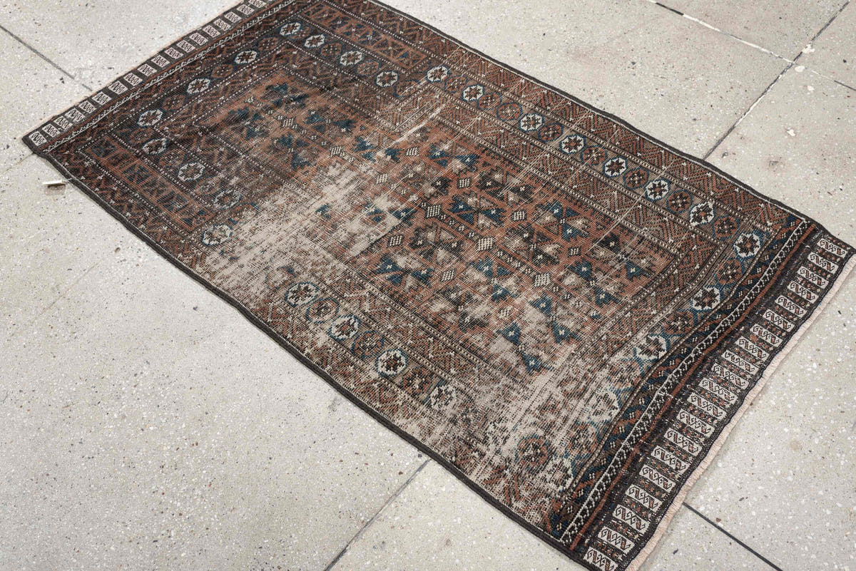 2' x 4' one-of-a-kind handmade antique Belouch small size rug. Color palette: rust, indigo, ivory, charcoal, camel, taupe