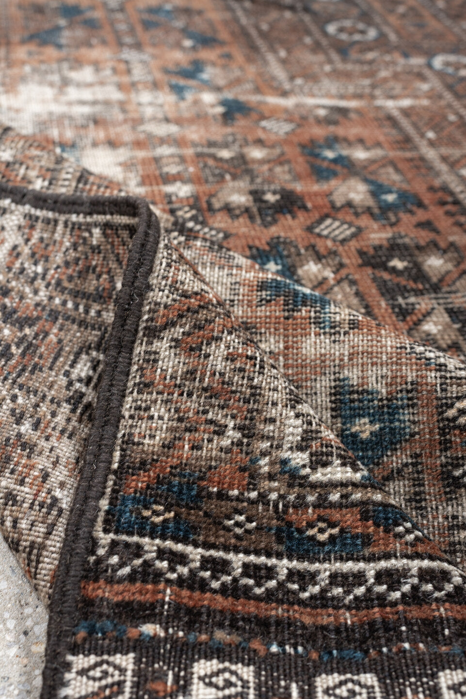 2' x 4' one-of-a-kind handmade antique Belouch small size rug. Color palette: rust, indigo, ivory, charcoal, camel, taupe