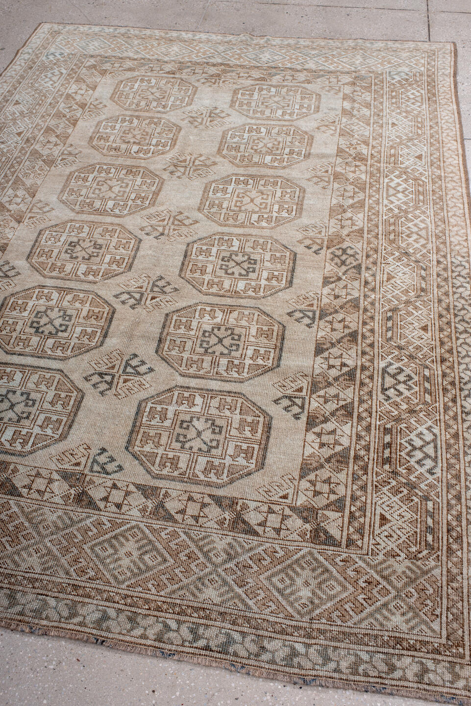 5' x 7' one-of-a-kind handmade antique Afghan rug. Color palette: ivory, taupe, camel, brown, charcoal, beige, gray, black