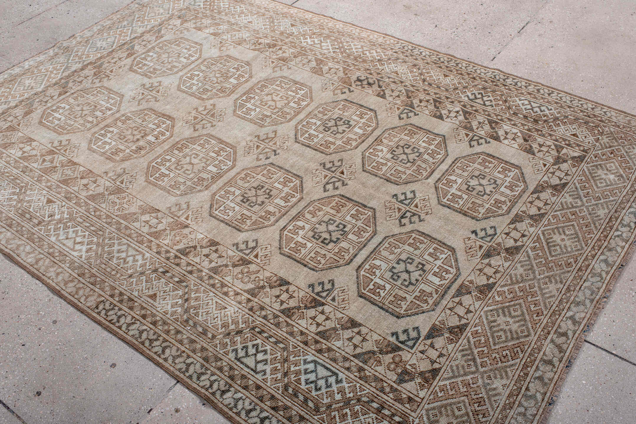 5' x 7' one-of-a-kind handmade antique Afghan rug. Color palette: ivory, taupe, camel, brown, charcoal, beige, gray, black