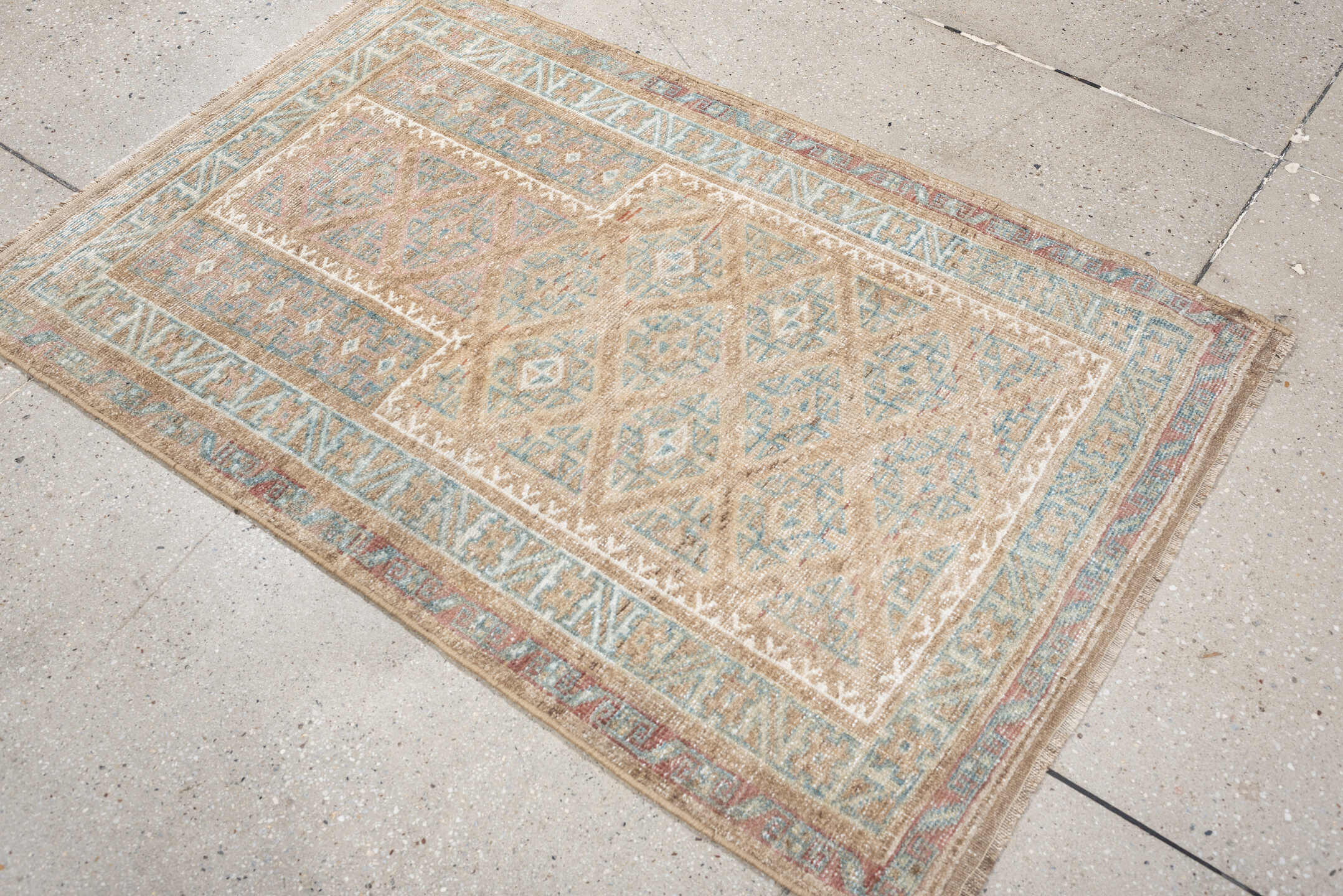 2' x 4' one-of-a-kind handmade antique Belouch small size rug. Color palette: camel, ivory, faded teal, taupe, muted rust
