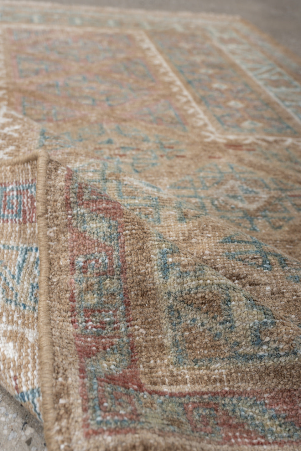 2' x 4' one-of-a-kind handmade antique Belouch small size rug. Color palette: camel, ivory, faded teal, taupe, muted rust