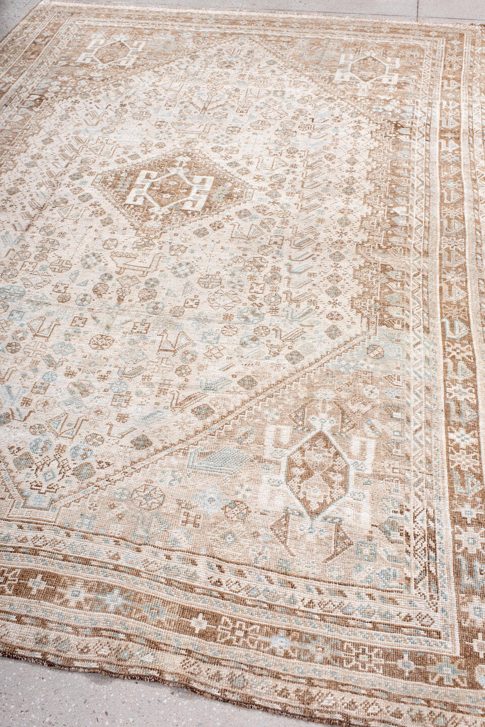 6' x 10' one-of-a-kind handmade antique Shiraz large size rug. Color palette: ivory, camel, taupe, pale blue, cream, sand