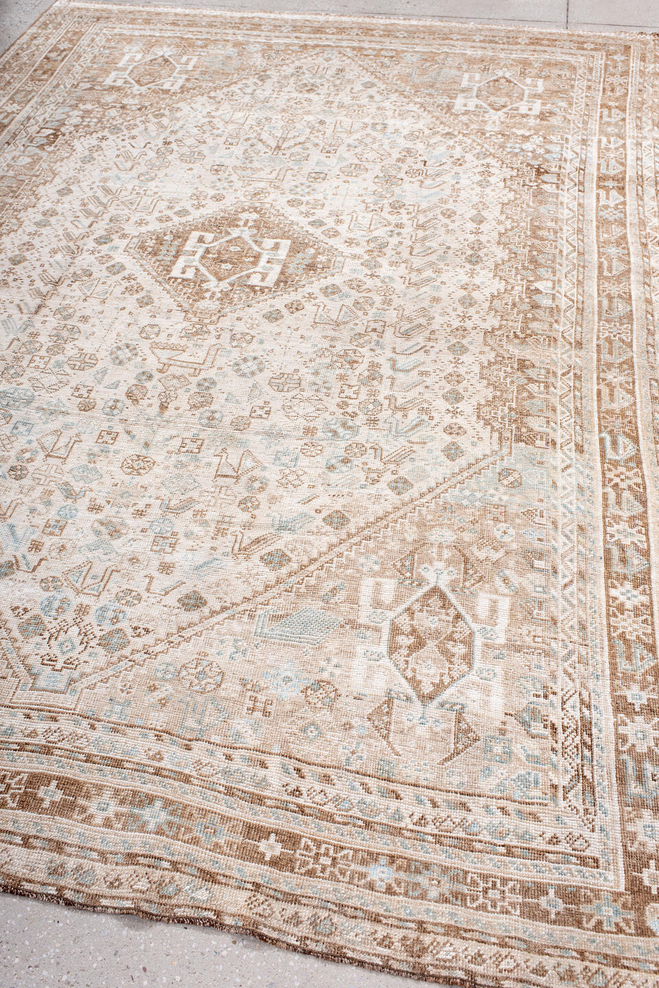 6' x 10' one-of-a-kind handmade antique Shiraz large size rug. Color palette: ivory, camel, taupe, pale blue, cream, sand