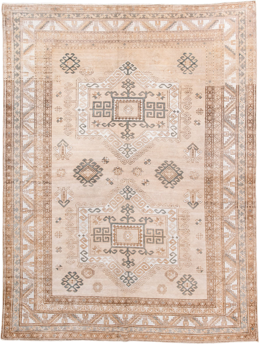 7' x 9' one-of-a-kind handmade antique Trans Caucasian rug. Color palette: ivory, camel, taupe, slate, sand, pewter, beige