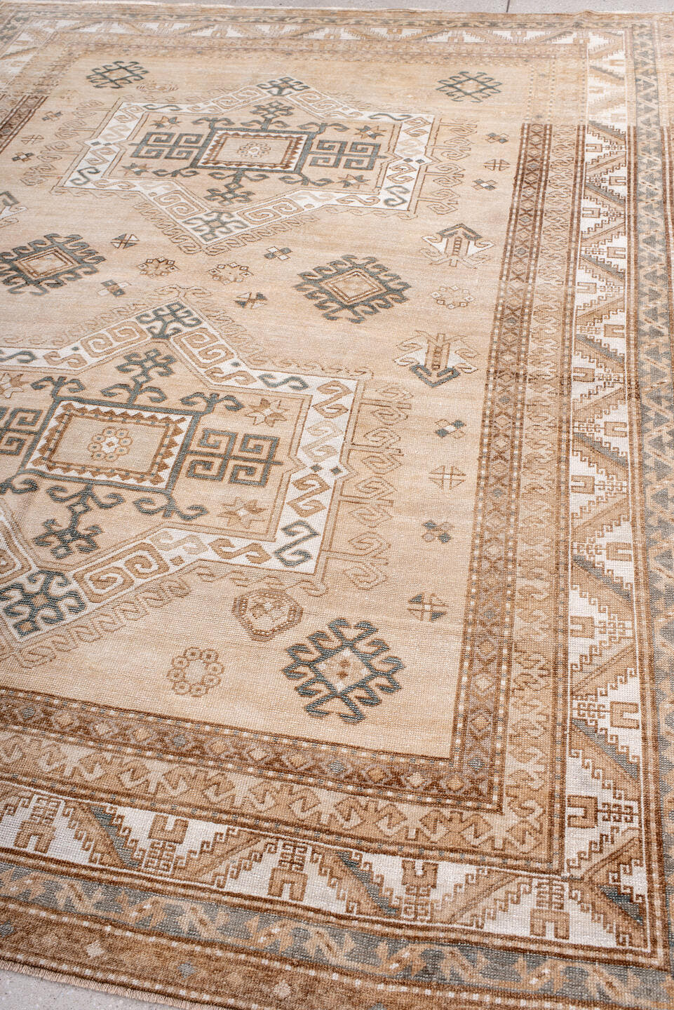 7' x 9' one-of-a-kind handmade antique Trans Caucasian rug. Color palette: ivory, camel, taupe, slate, sand, pewter, beige