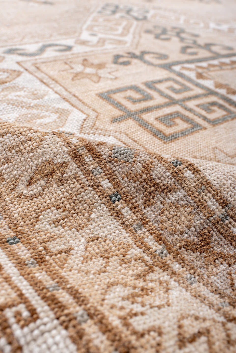 7' x 9' one-of-a-kind handmade antique Trans Caucasian rug. Color palette: ivory, camel, taupe, slate, sand, pewter, beige