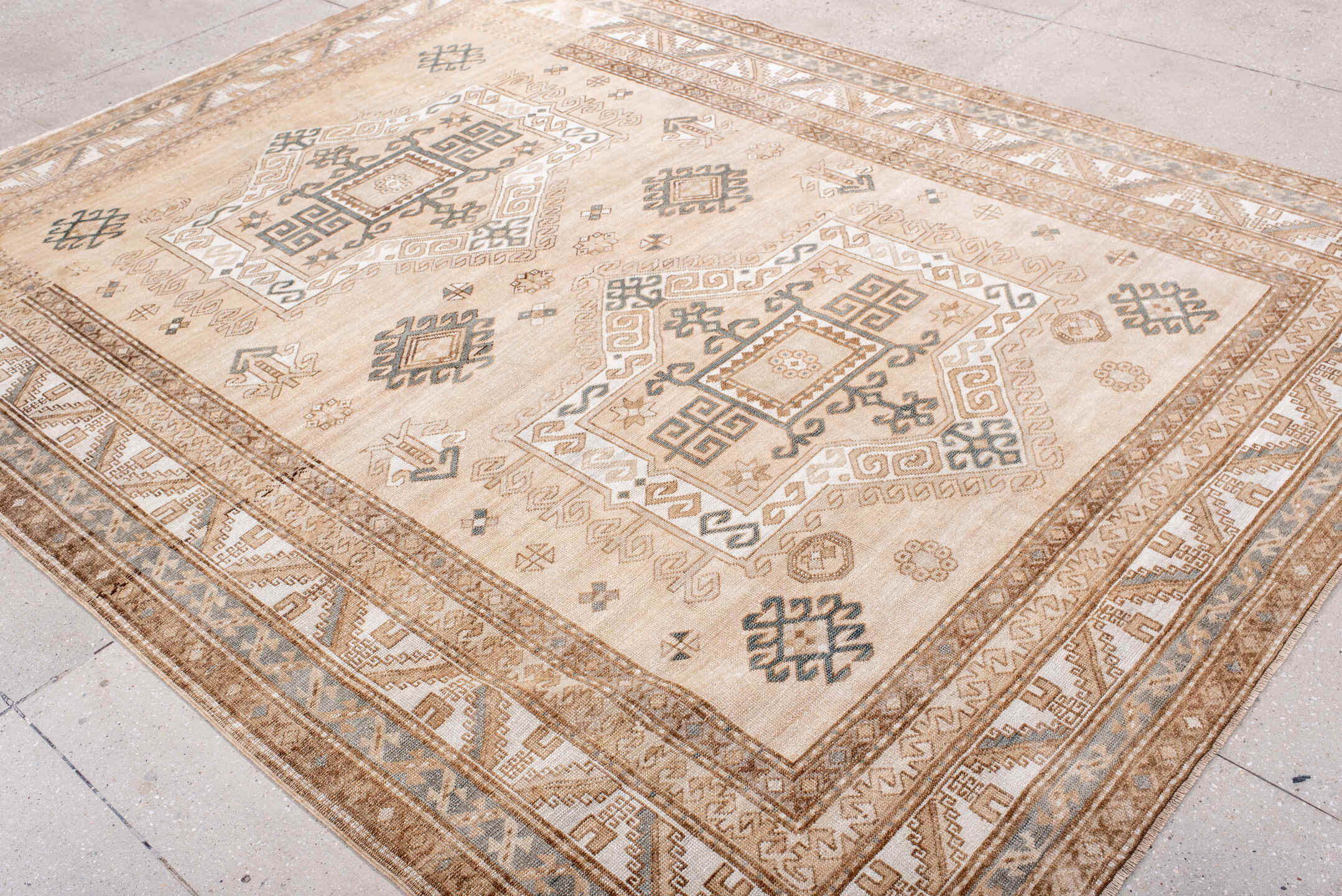 7' x 9' one-of-a-kind handmade antique Trans Caucasian rug. Color palette: ivory, camel, taupe, slate, sand, pewter, beige