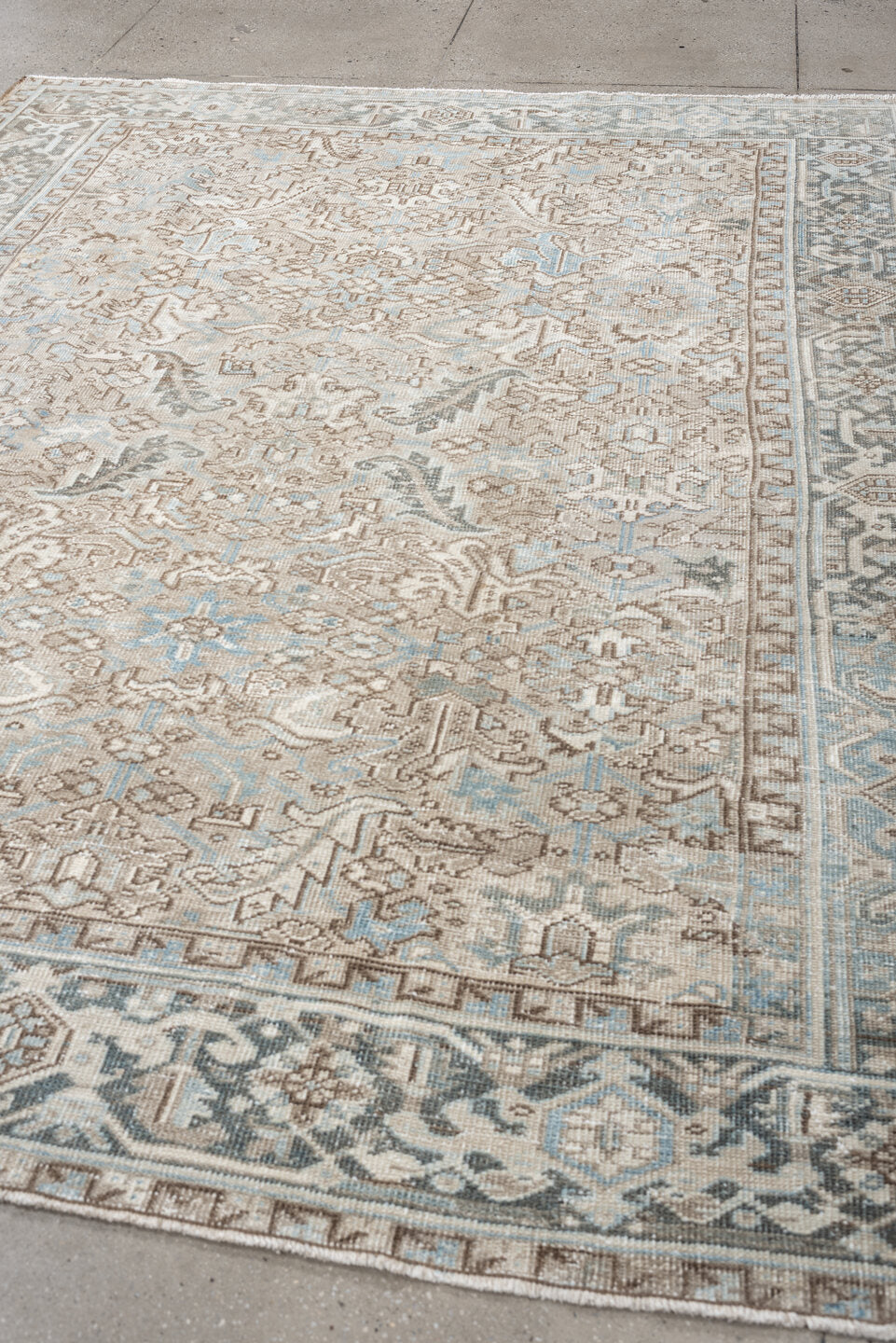 7' x 9' one-of-a-kind handmade vintage Heriz rug. Color palette: ivory, pale blue, taupe, slate, light gray, beige