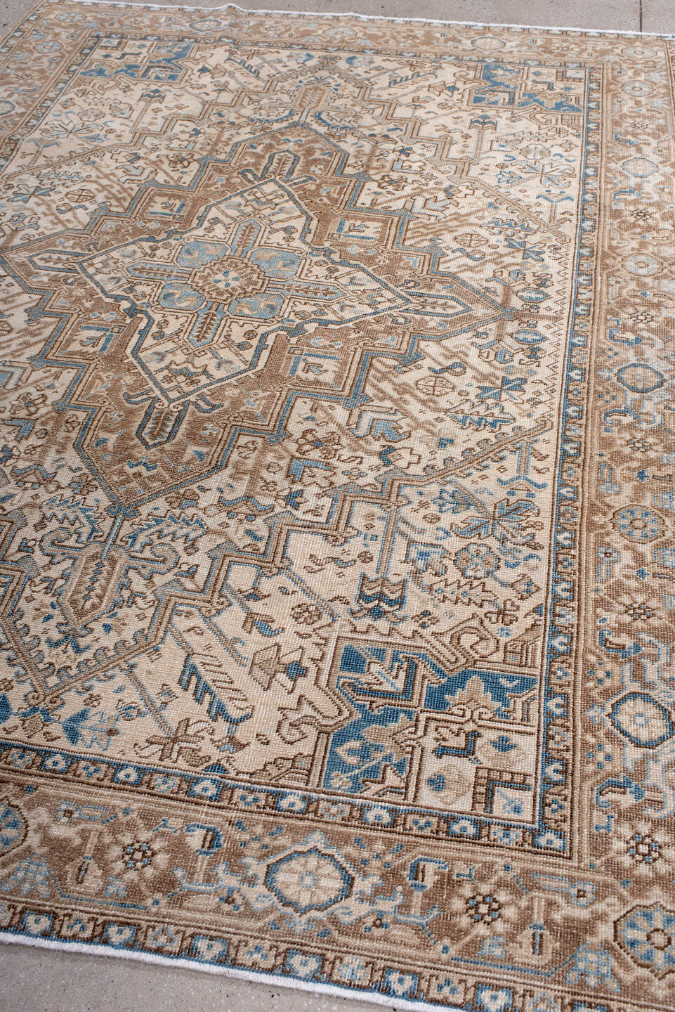 6' x 8' one-of-a-kind handmade antique Heriz medium size rug. Color palette: ivory, taupe, sky blue, camel, brown, beige